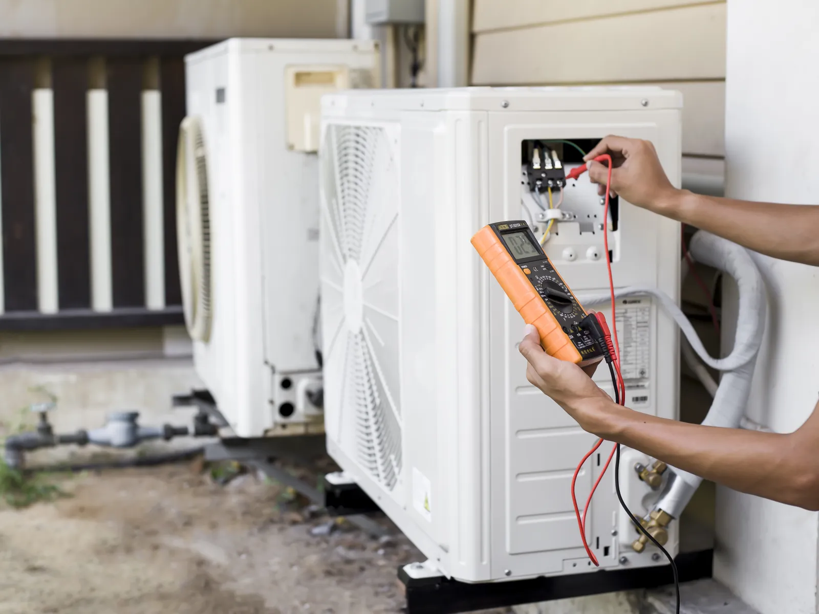 a person opening a white refrigerator