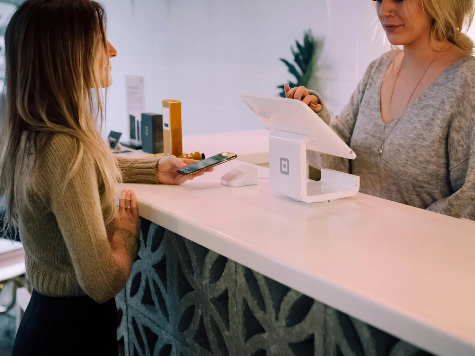 a woman showing a woman something on the phone