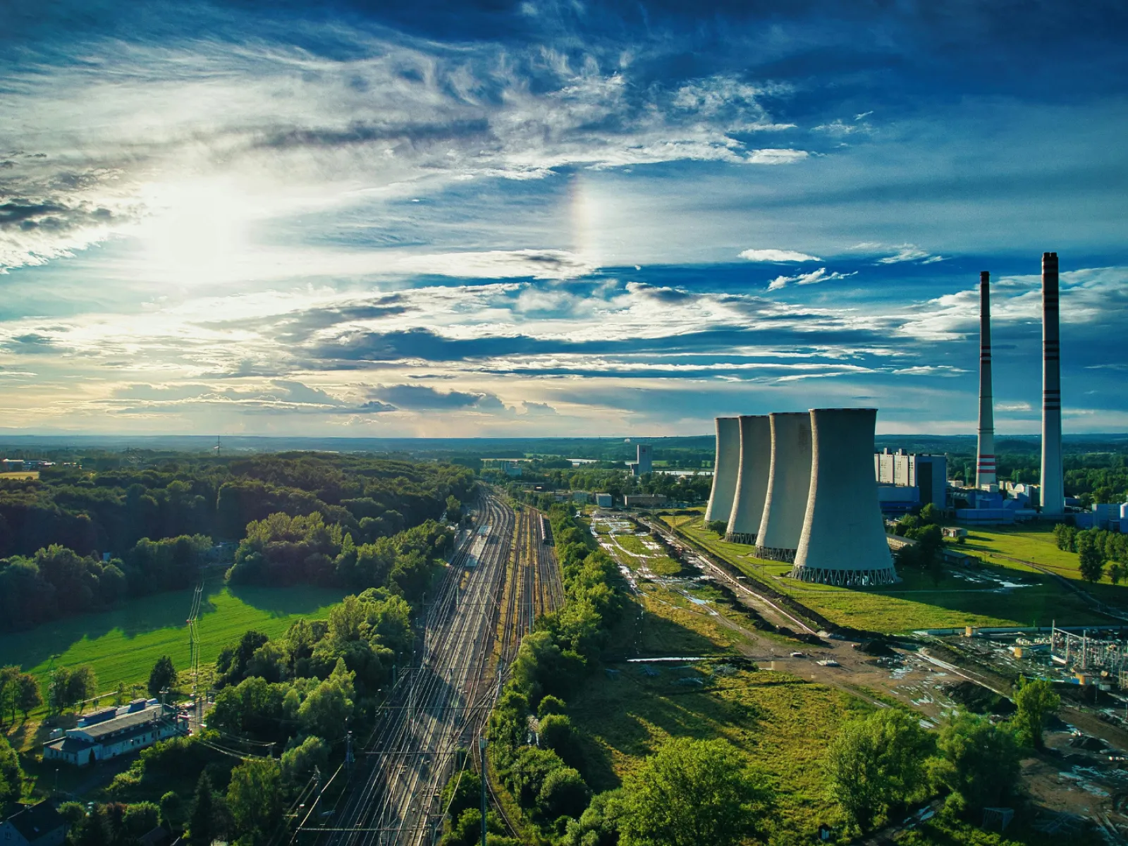 a large factory with a road and trees around it