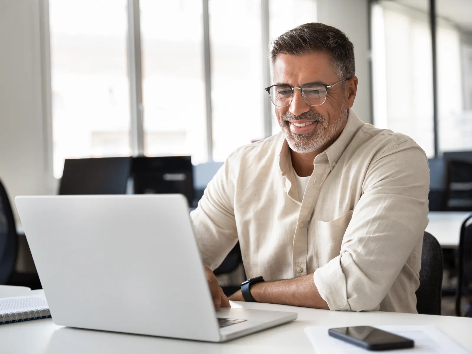 a man sitting at a table with a laptop