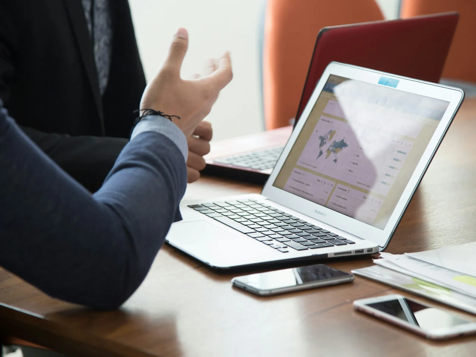 a person pointing at a laptop