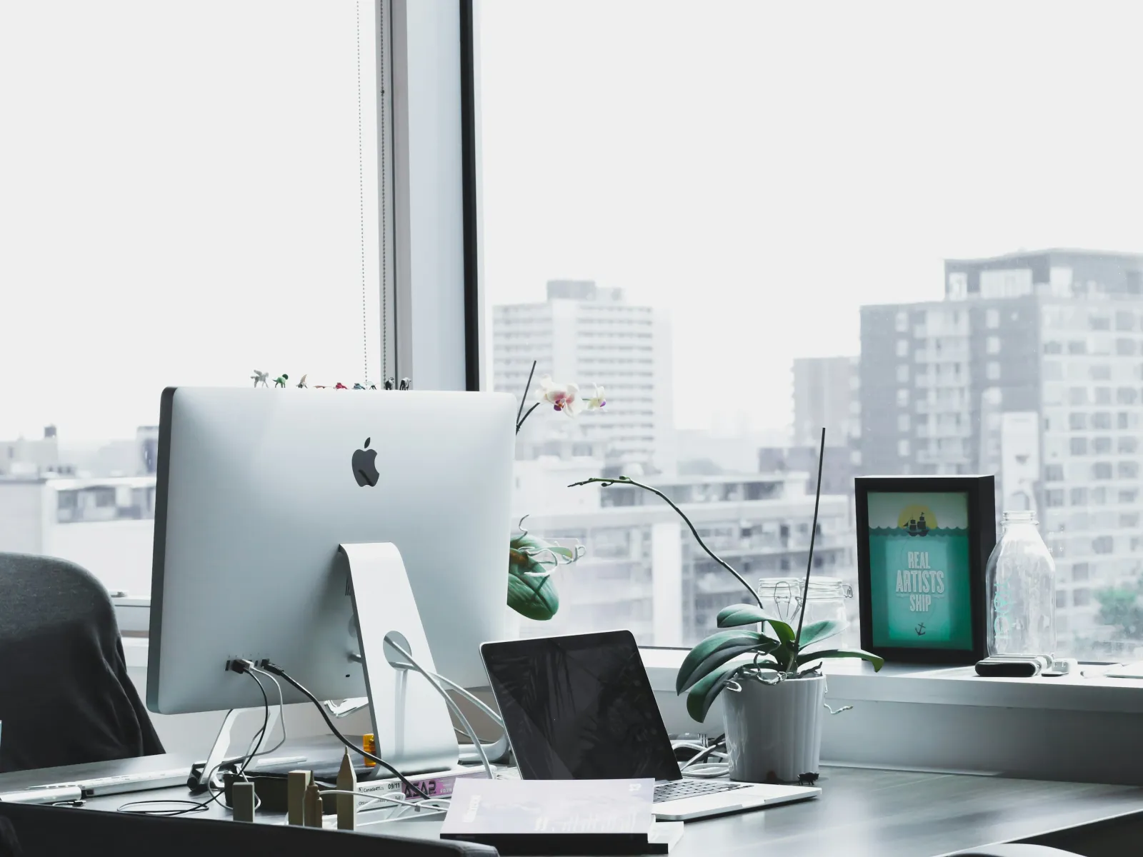 a desk with a computer and other office items