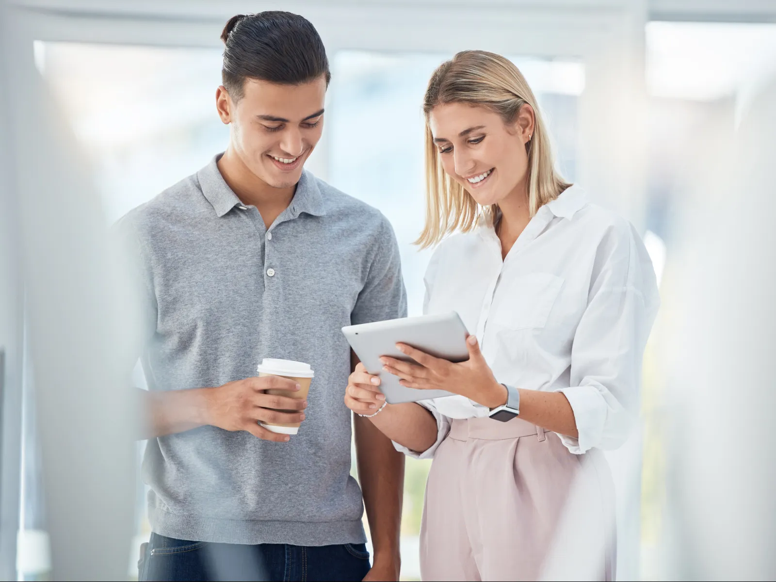 a man and a woman looking at a tablet