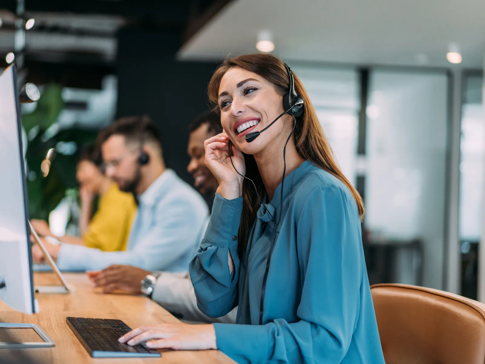 a woman wearing headphones and sitting at a desk