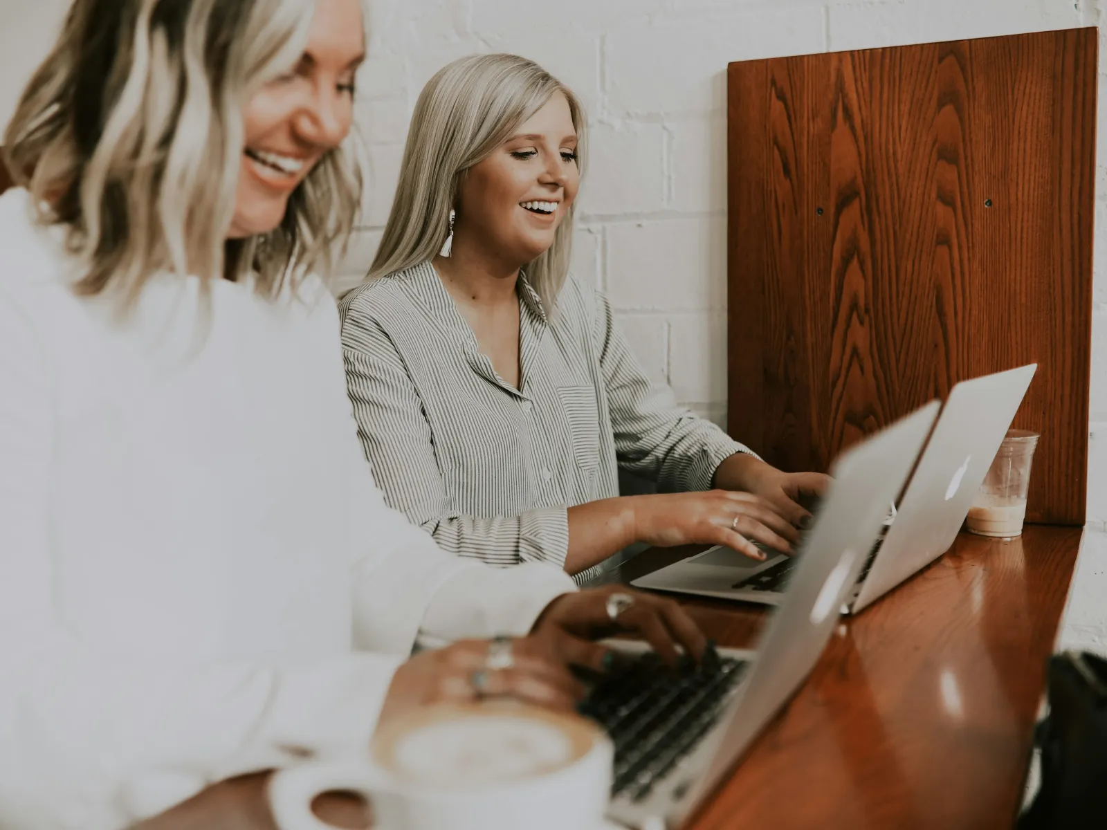 a couple of women looking at a laptop