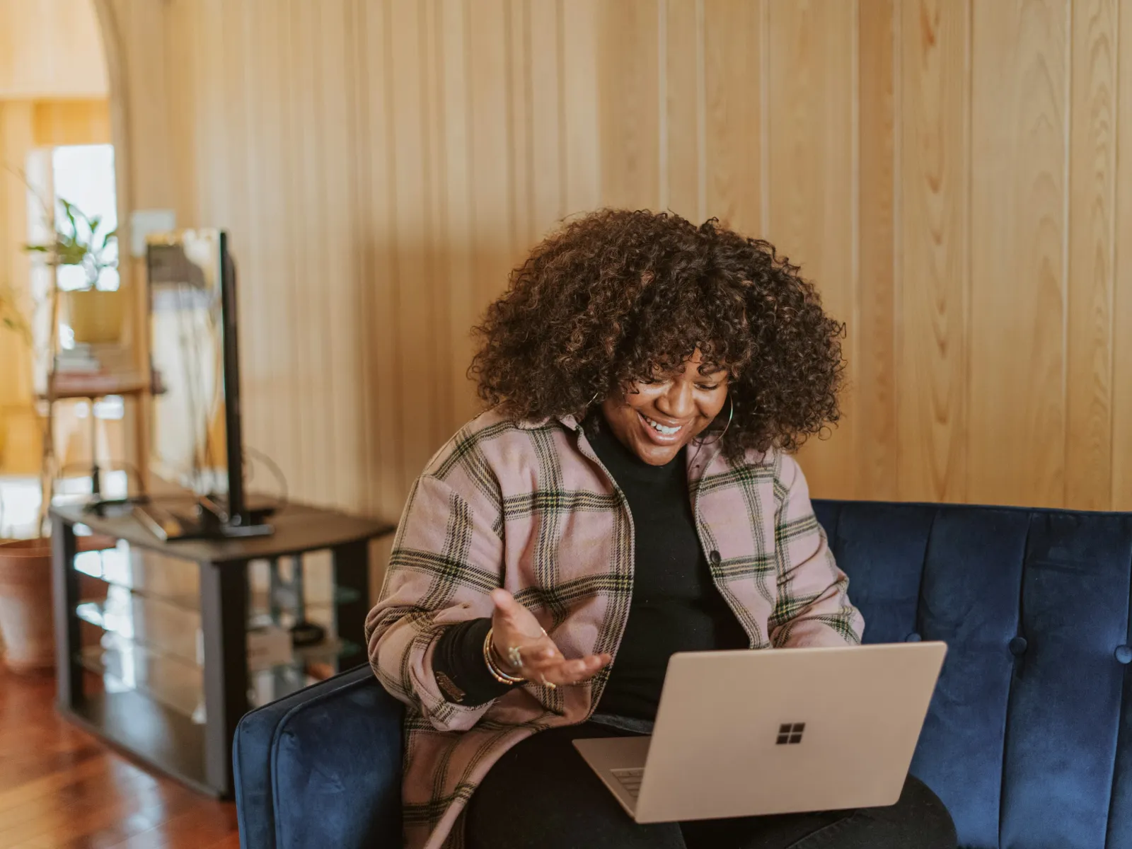 a man sitting on a couch with a laptop