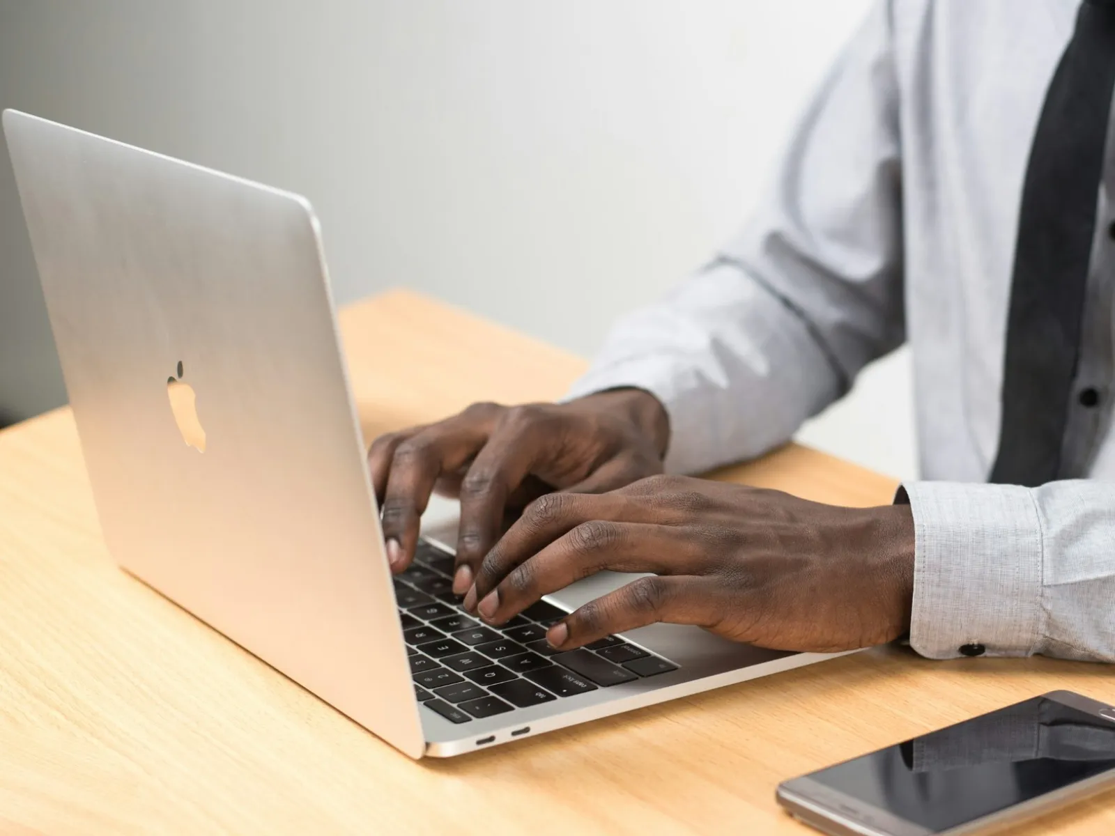 a man in a suit using a laptop