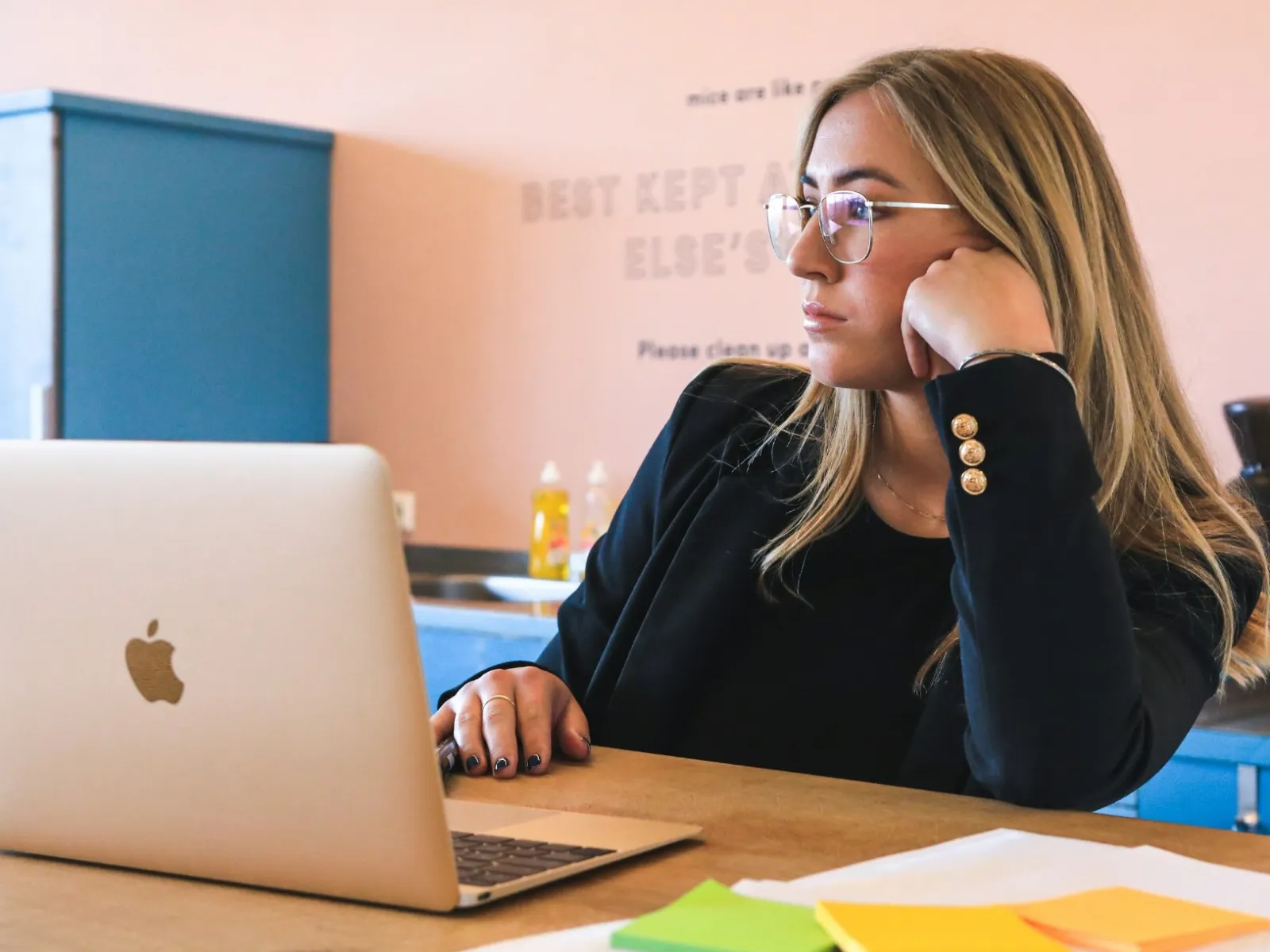a woman sitting at a desk with a laptop