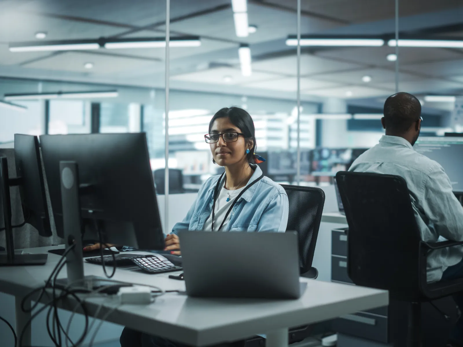 a man and a woman working at computers