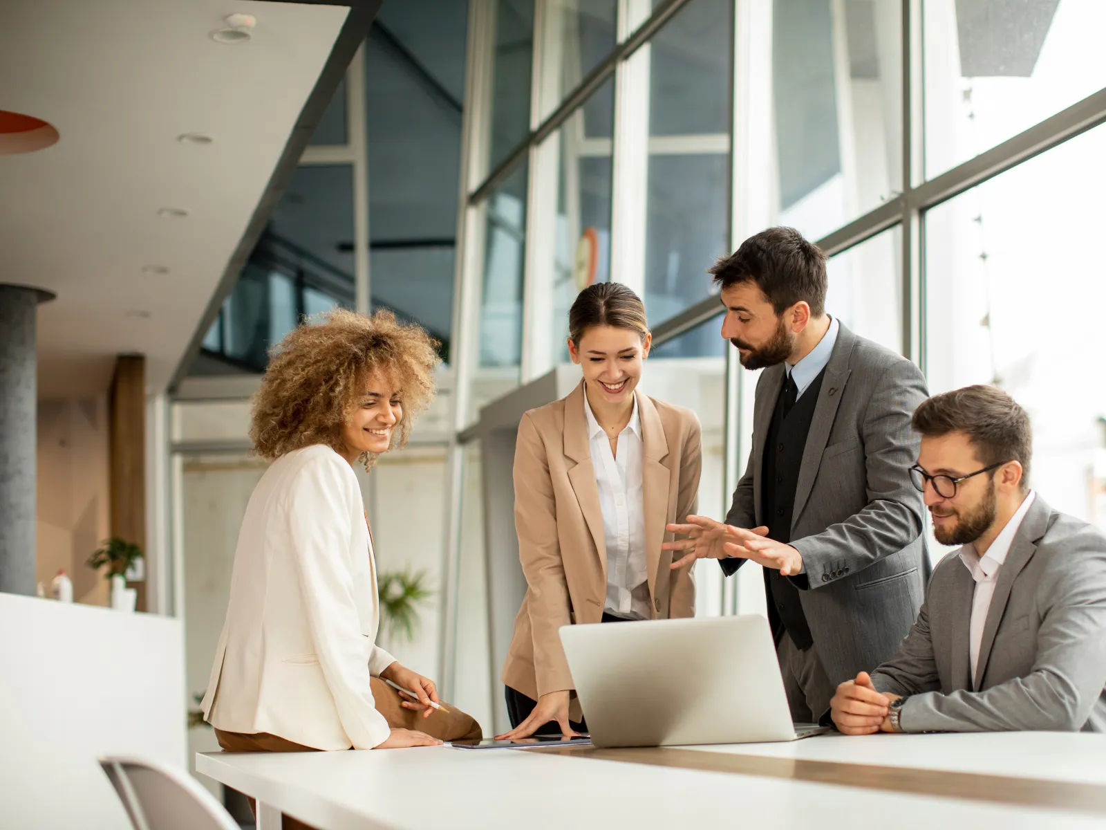 a group of people looking at a laptop