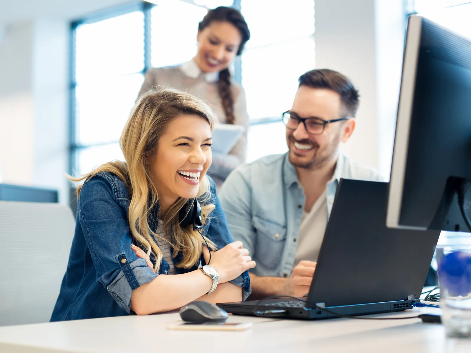 a few people working at a computer