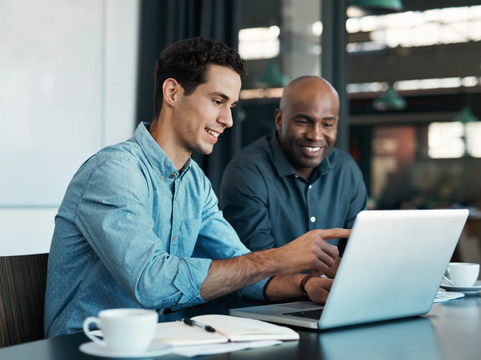 a few men looking at a laptop
