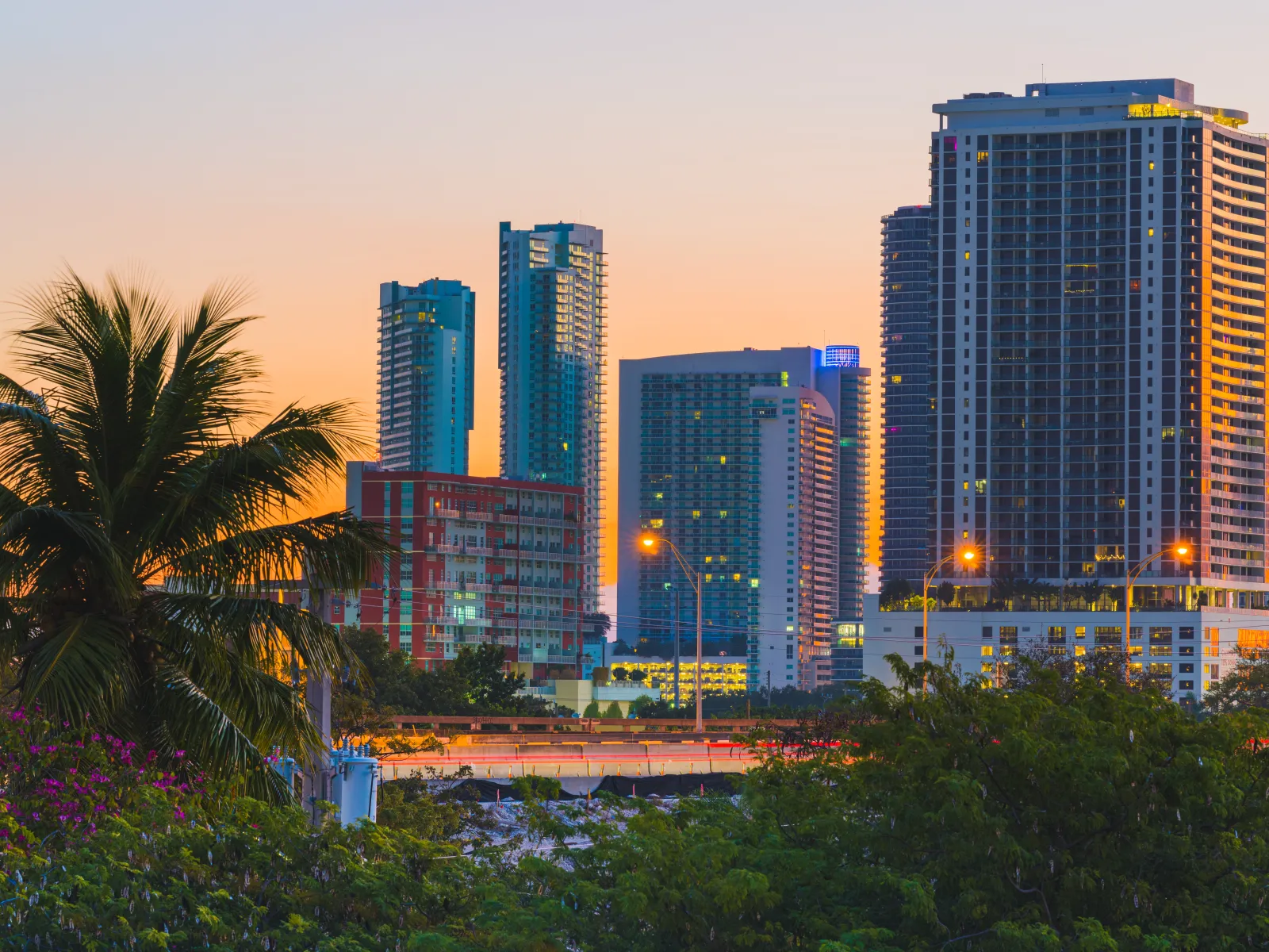 Chicago River flowing through downtown with multiple bridges and high-rise buildings on both sides under a clear sky