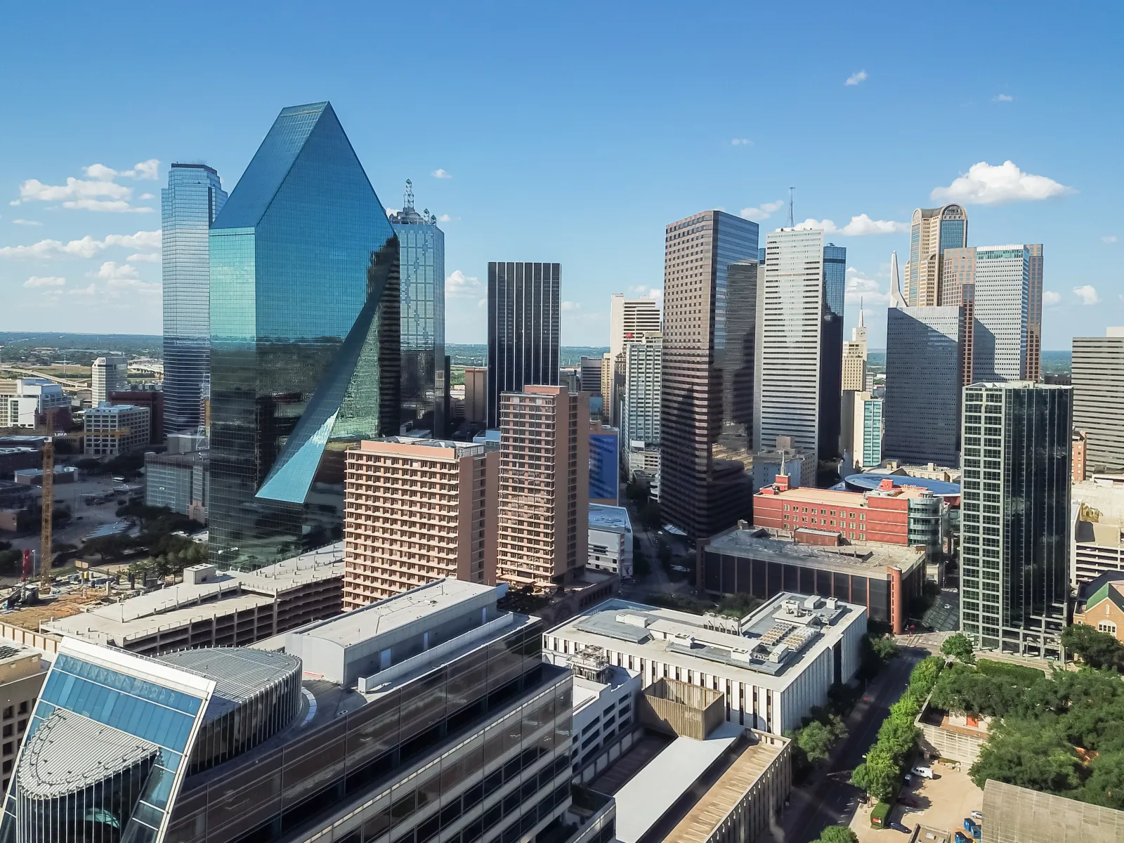 Downtown Dallas skyline with modern skyscrapers under a clear blue sky on a sunny day