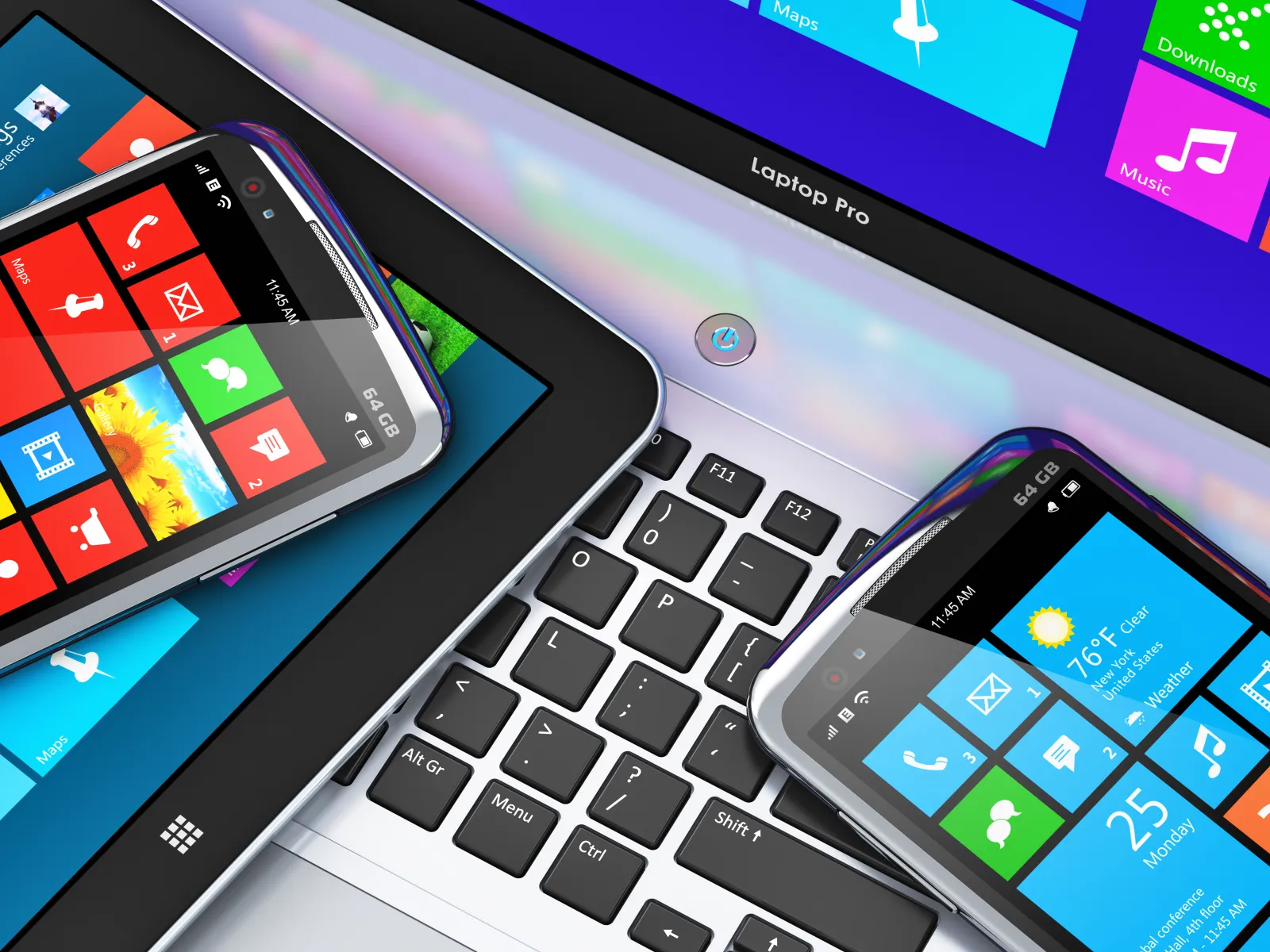 Modern touchscreen devices including two smartphones and a tablet displaying colorful app tiles on a laptop keyboard.