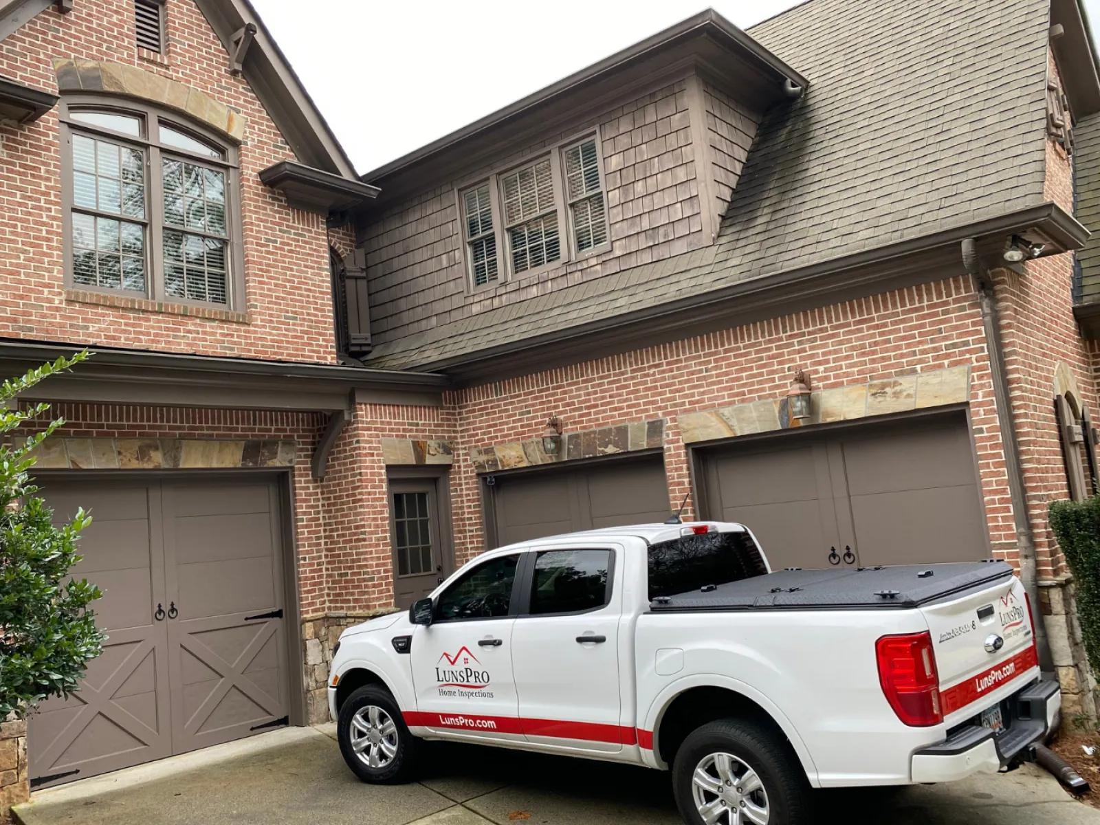 a white truck parked in front of a house