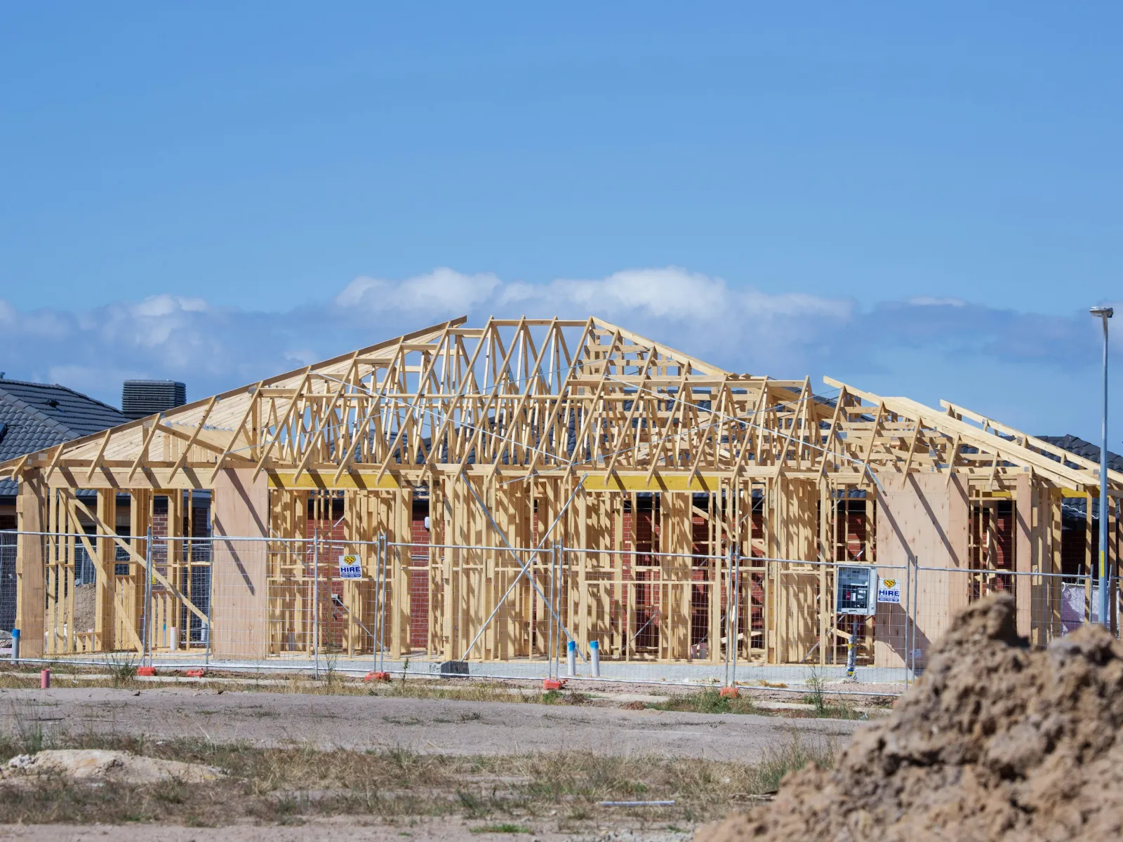 Wooden frame of a house under construction with LunsPro Inspection Group