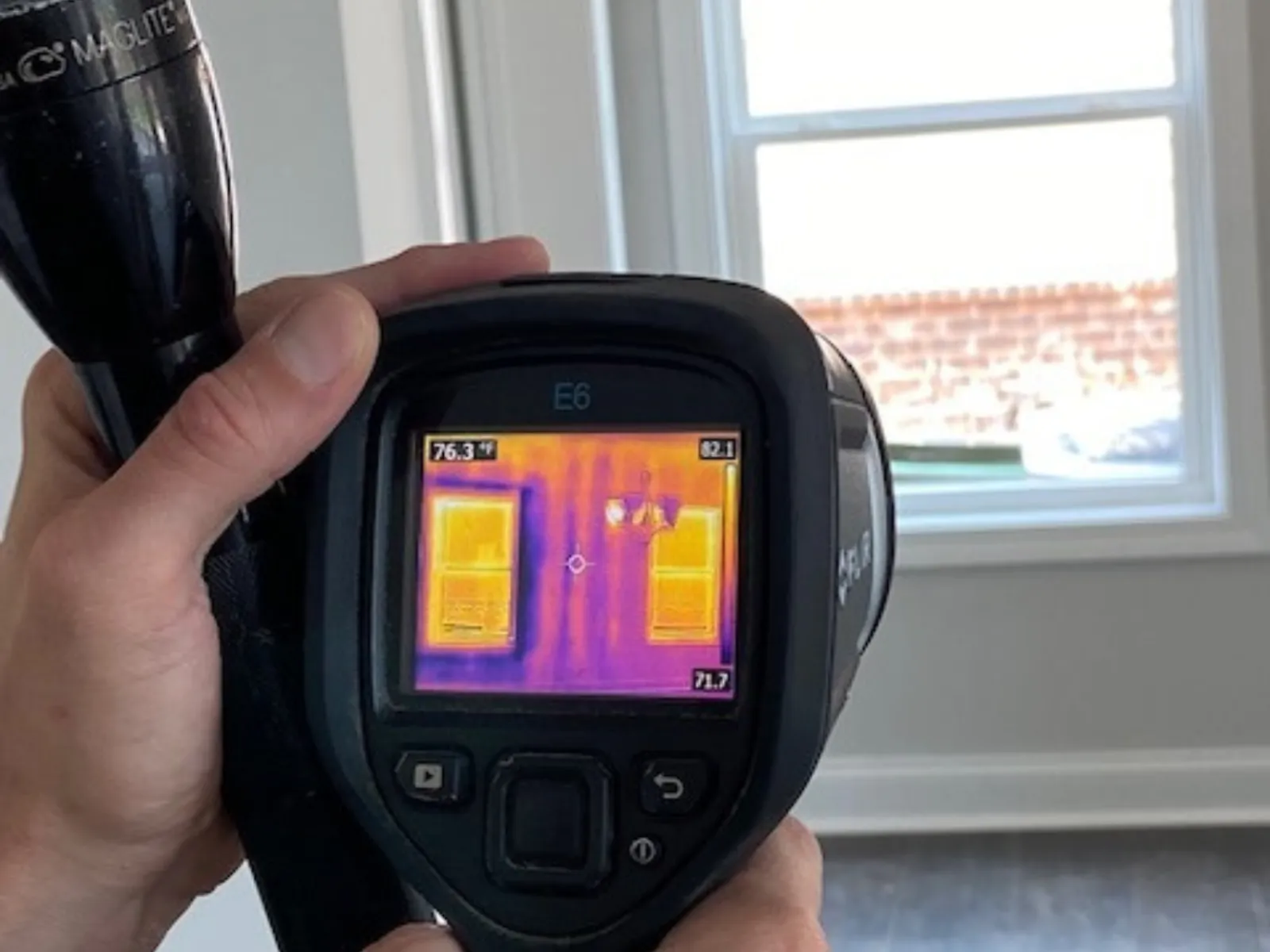 a person holding an infrared camera