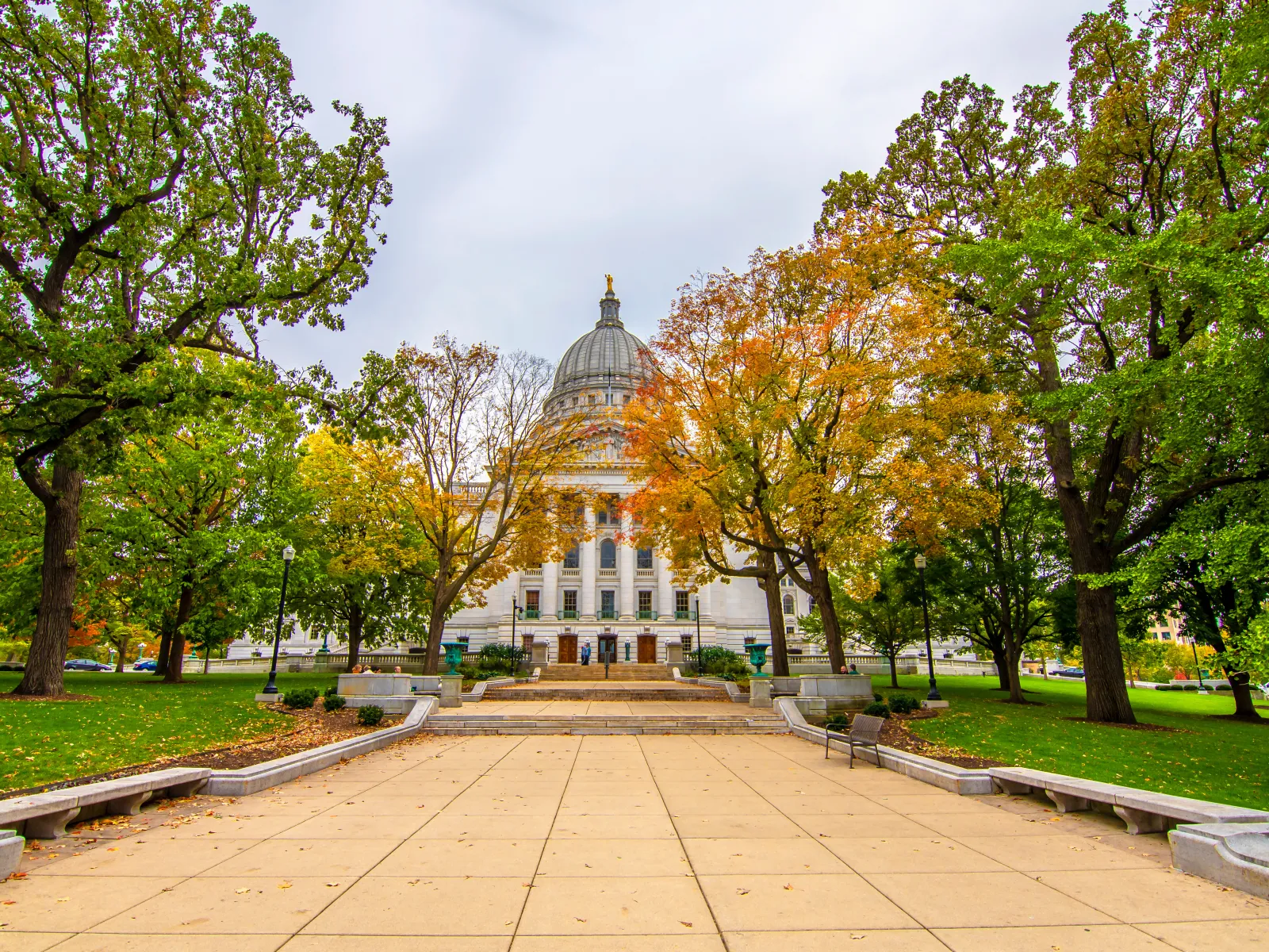 a large building with a dome and trees in front of it
