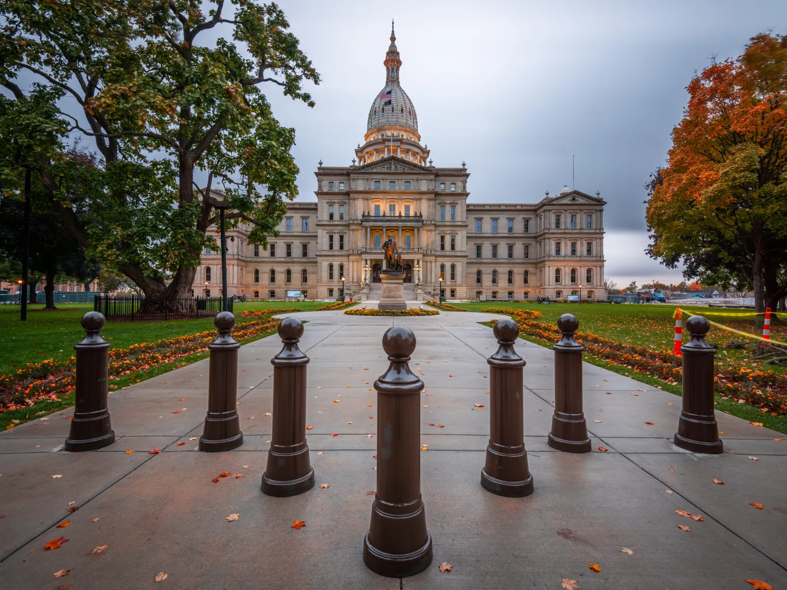 a large building with a gold domed roof behind a row of black and white chess pieces