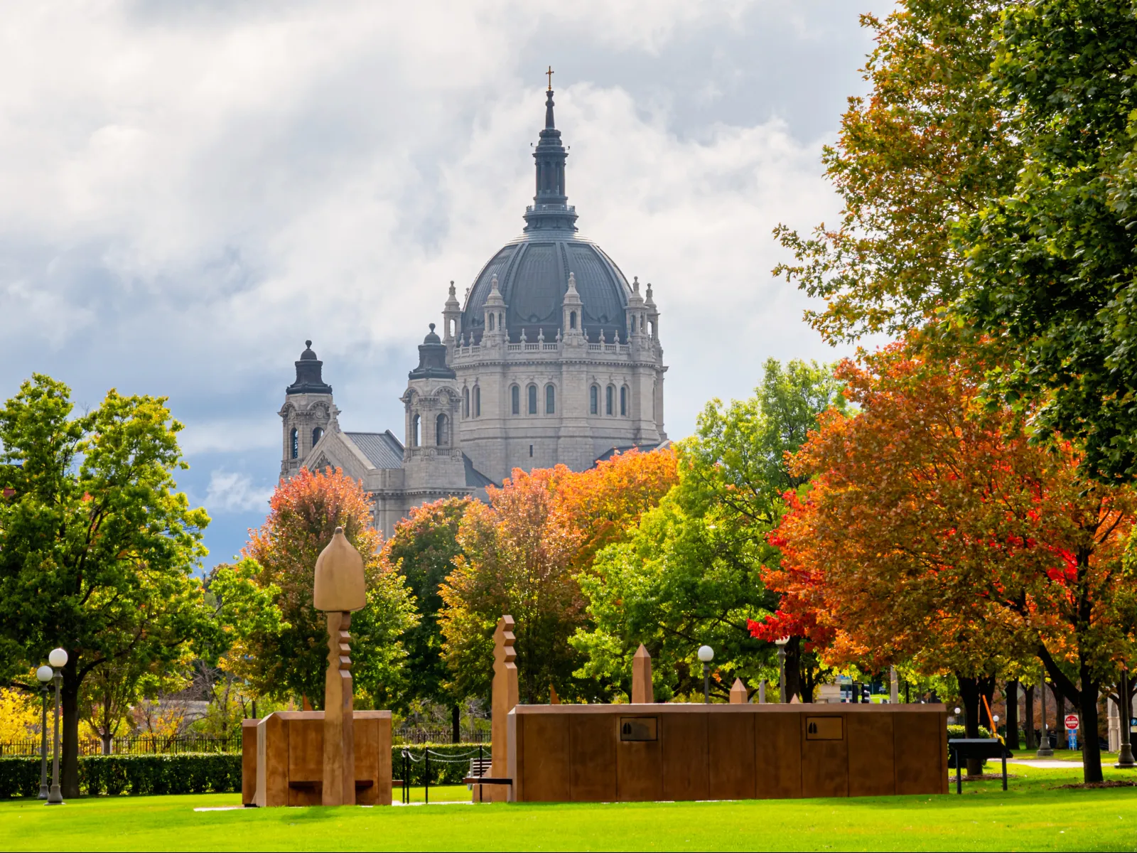 a large building with a dome and trees in front of it