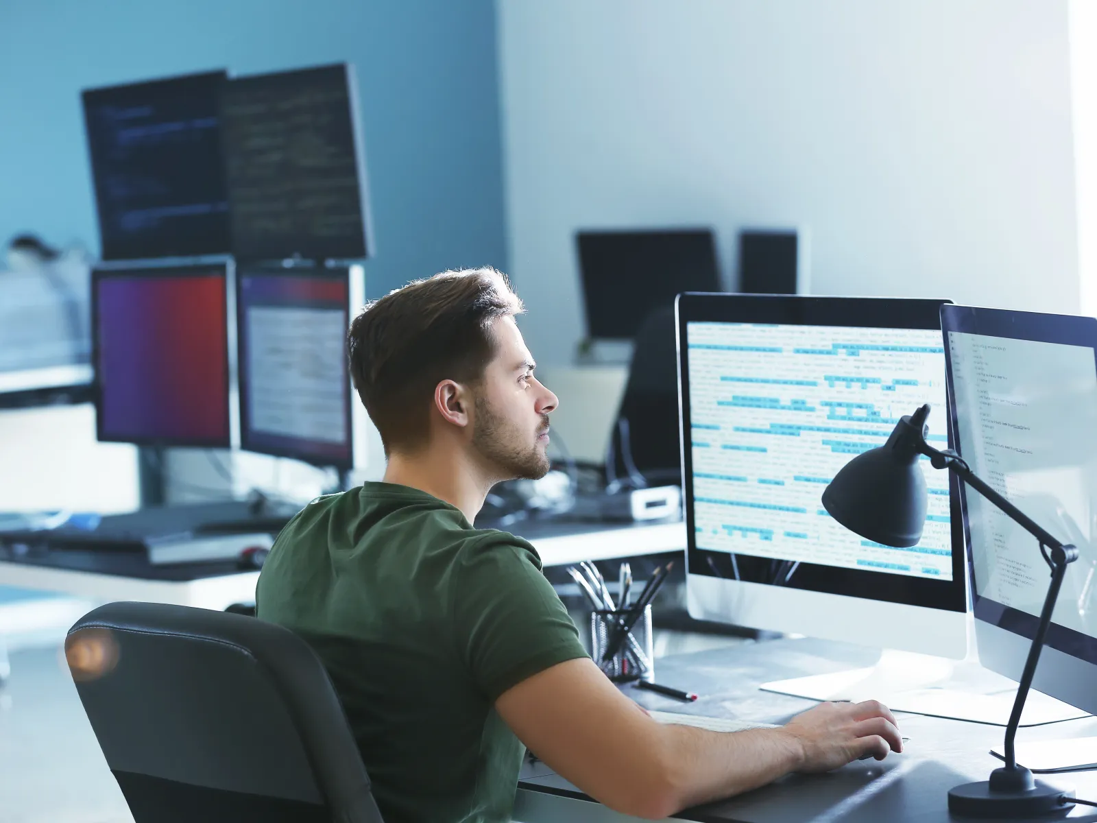 a person sitting at a desk with a computer
