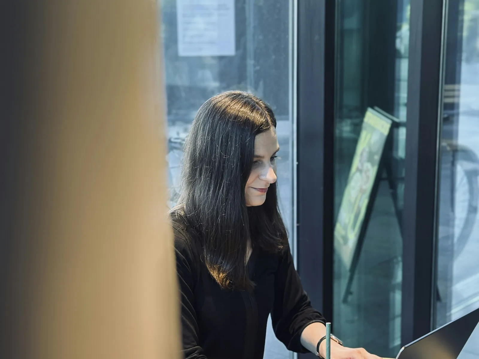 a person sitting at a table with a laptop