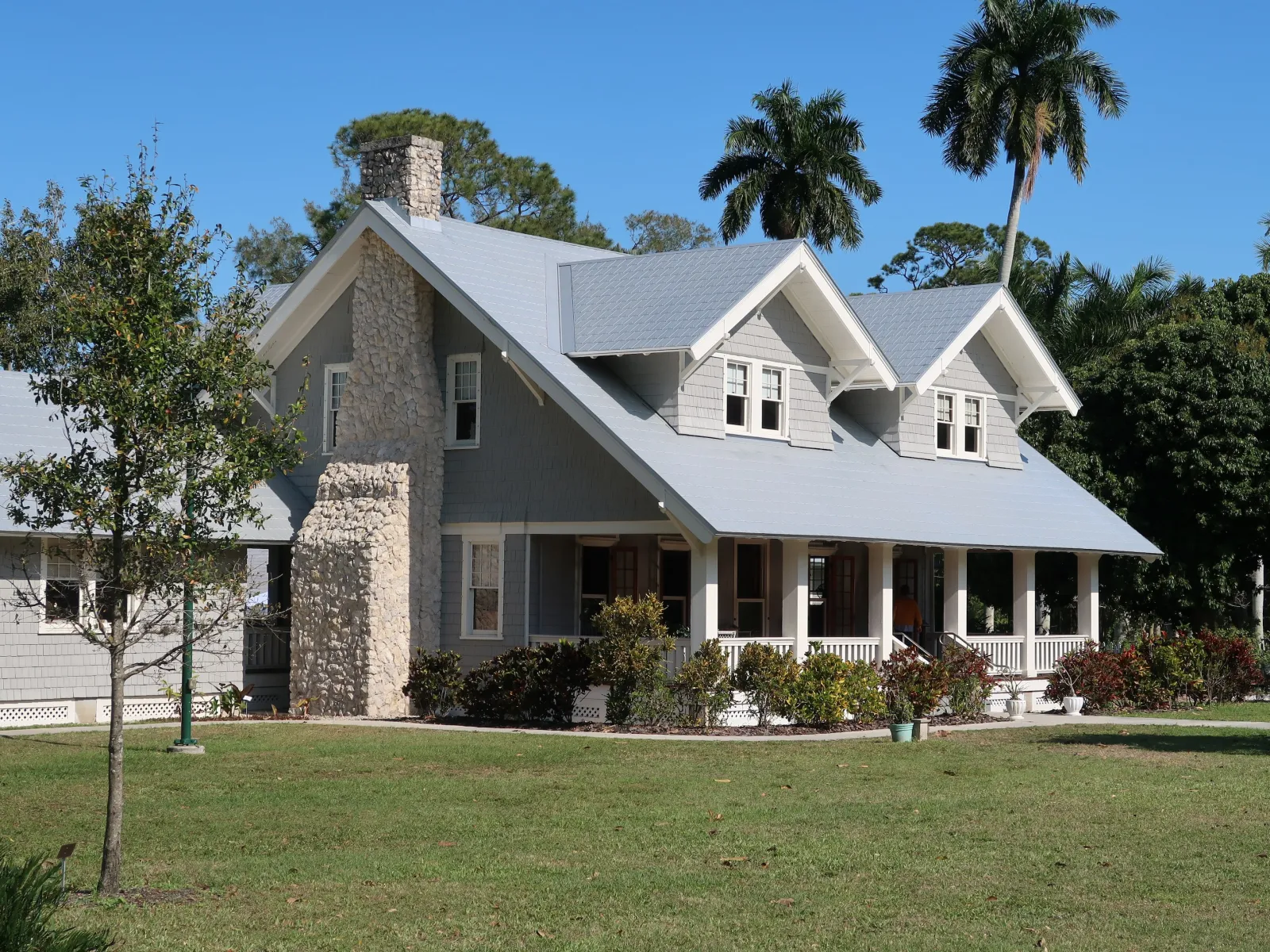a large white house with trees and grass in front of it