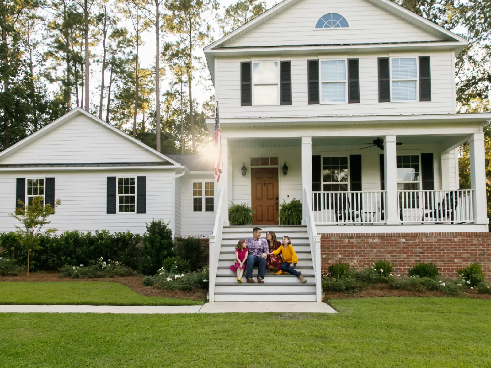 a family in the front of the house