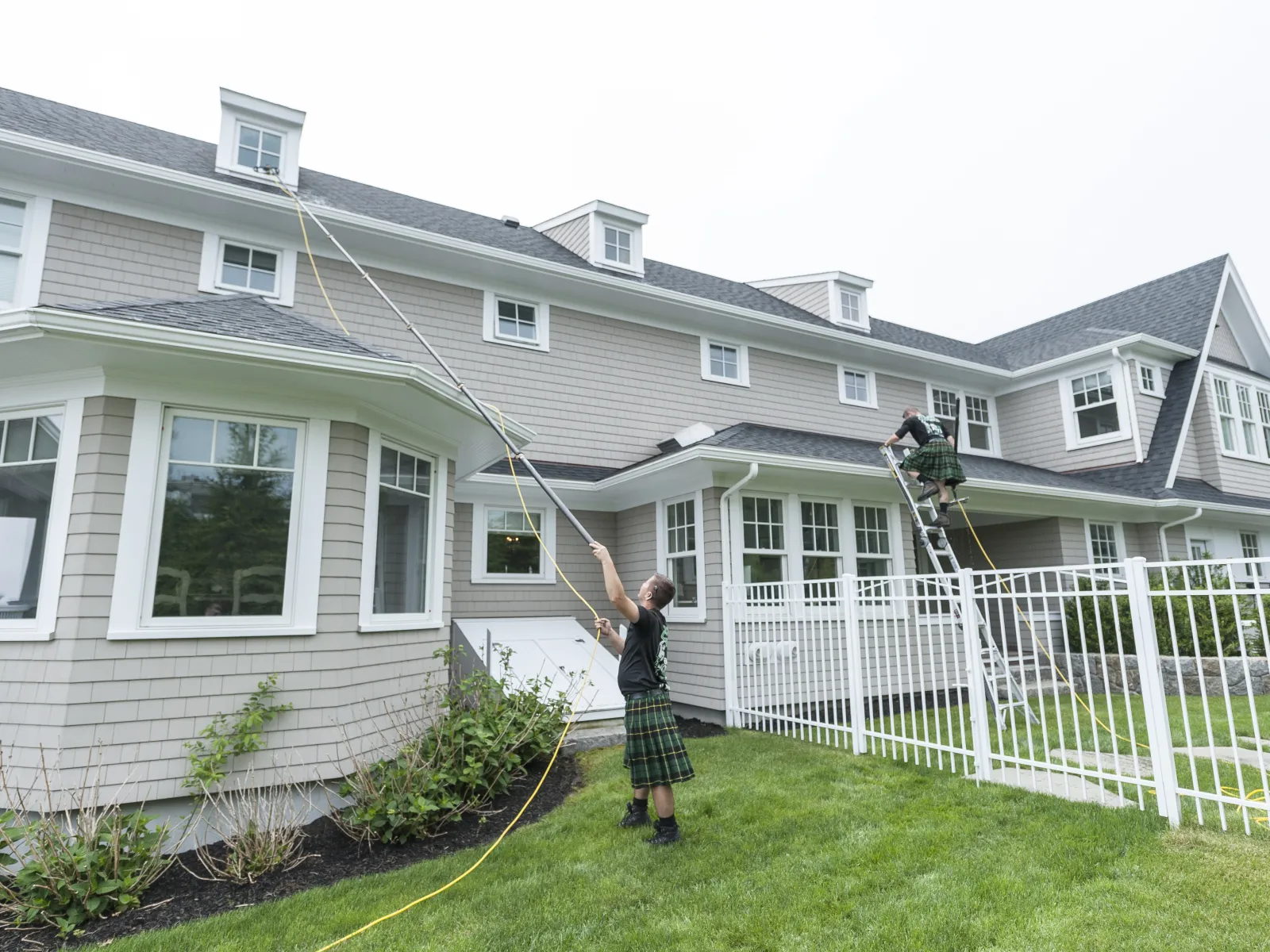 a person holding a rope in front of a house