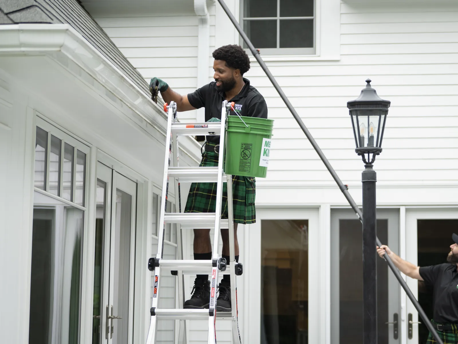 a man on a ladder holding a box