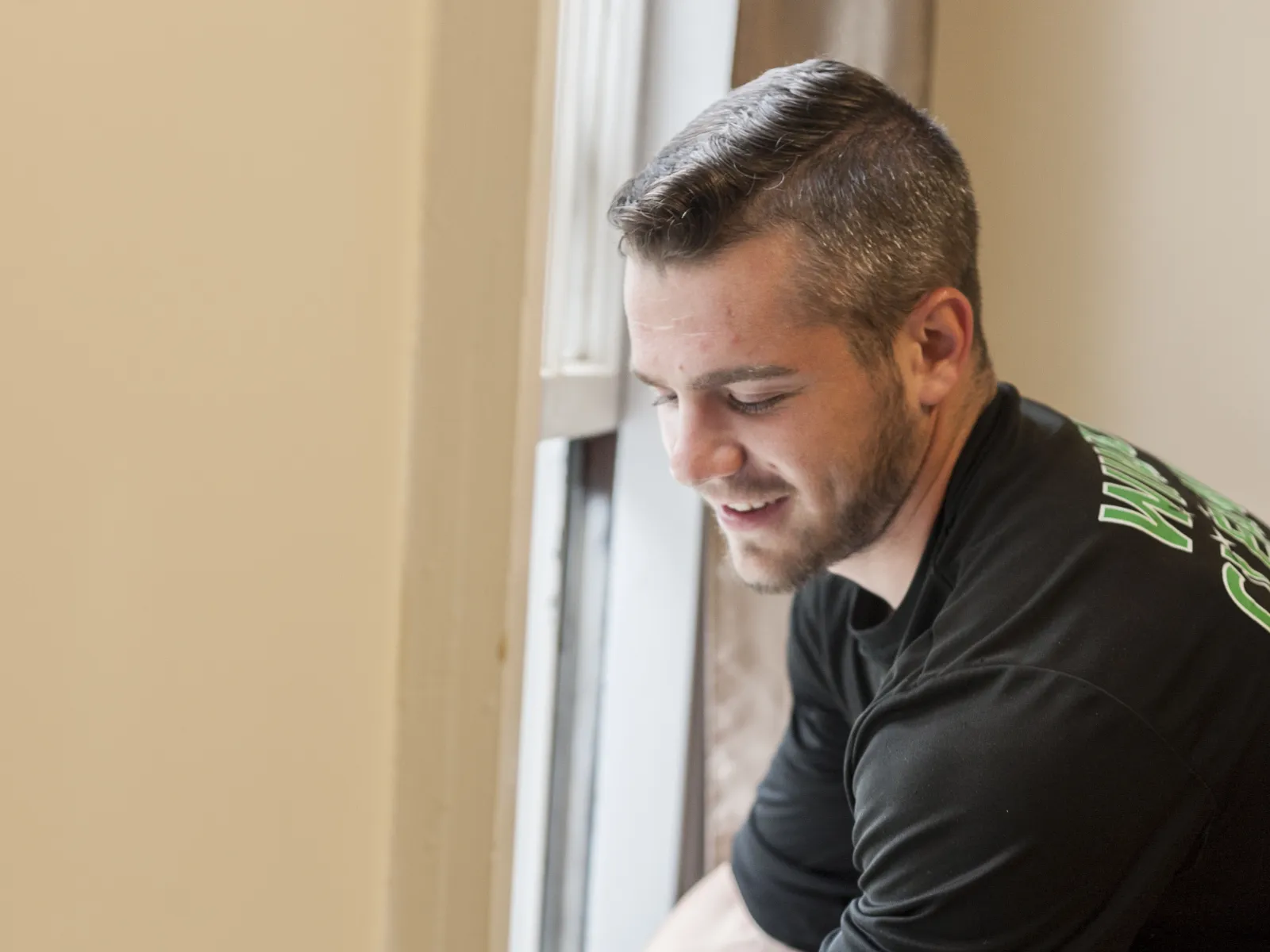 a man leaning against a wall