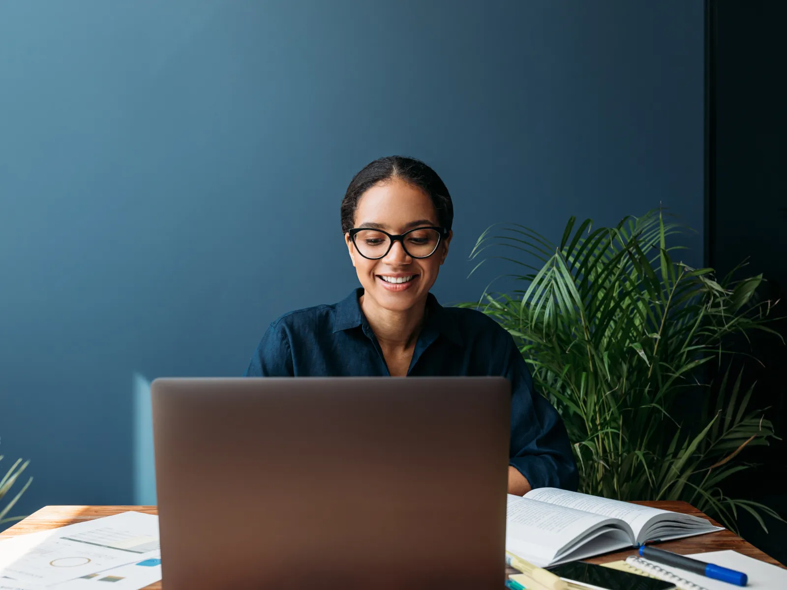 a person sitting at a table with a laptop