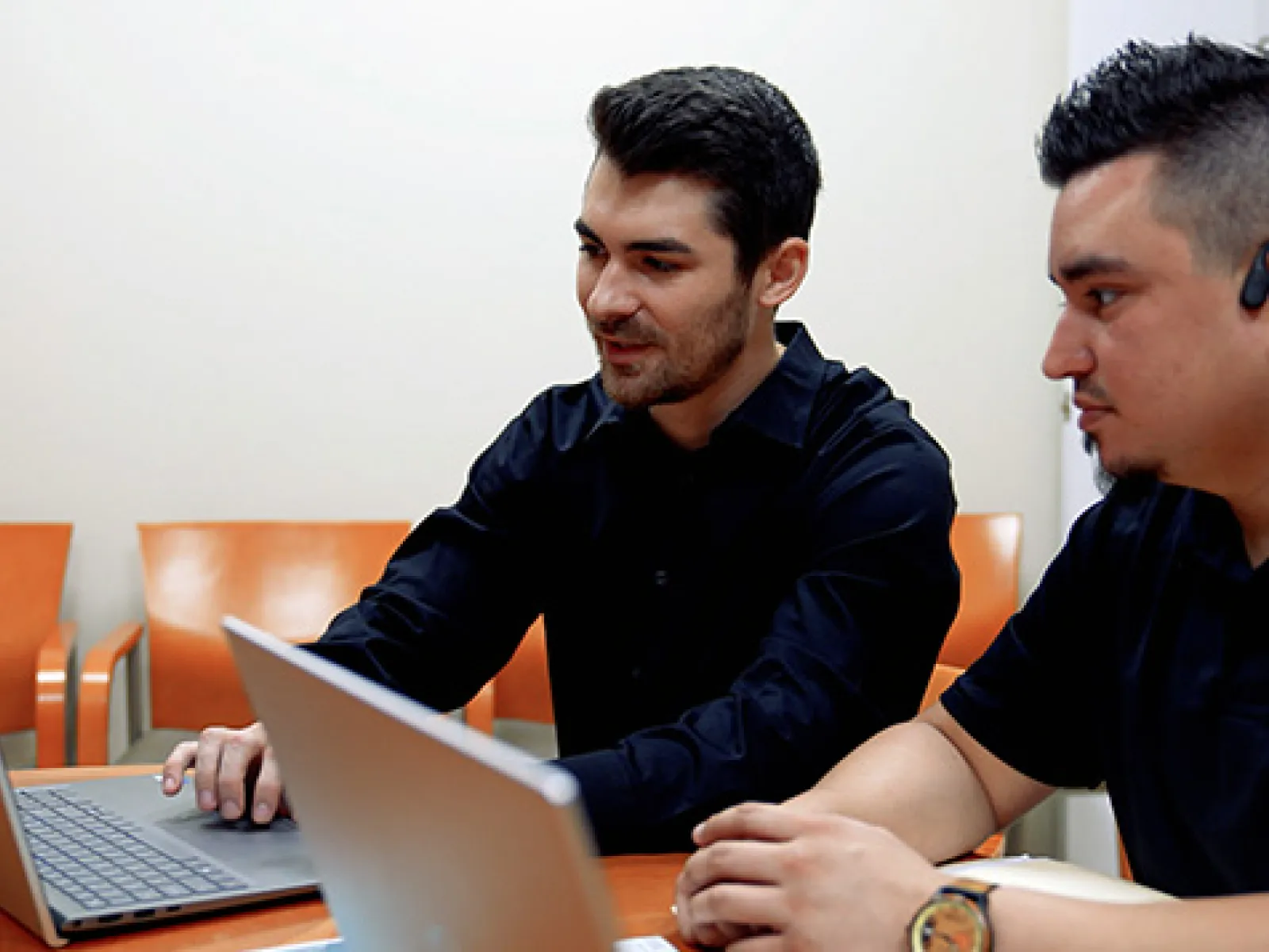 men looking at a laptop