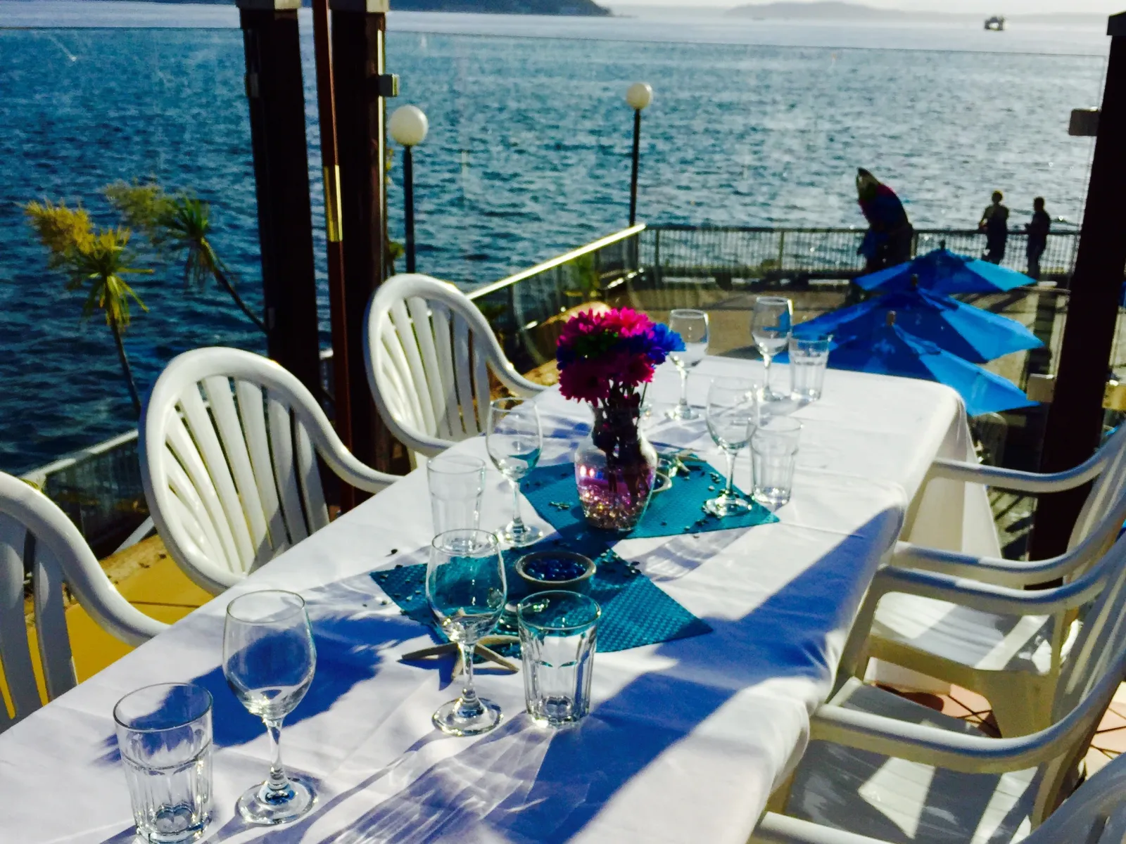 a table with glasses and umbrellas
