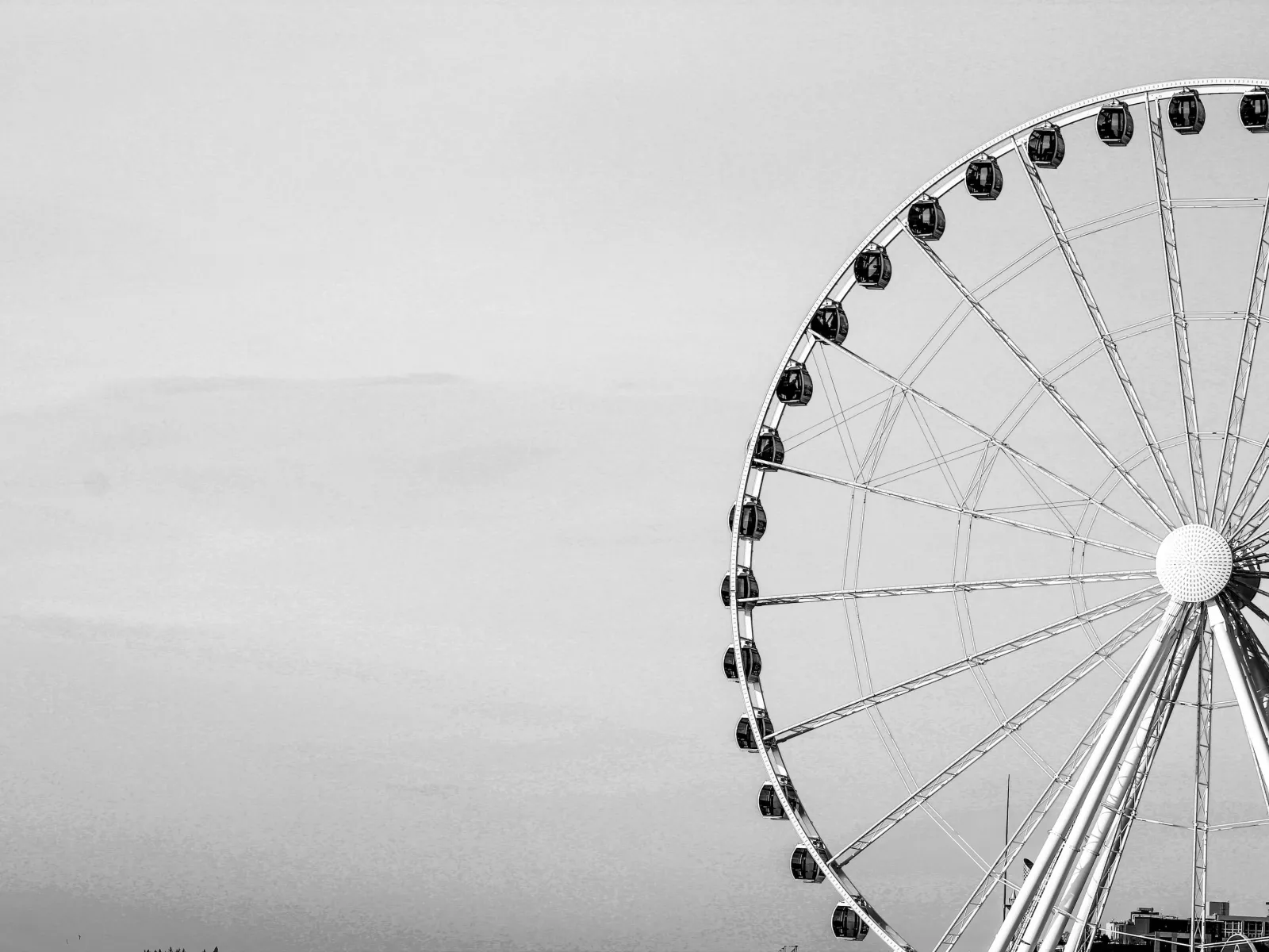 a ferris wheel with a cloudy sky