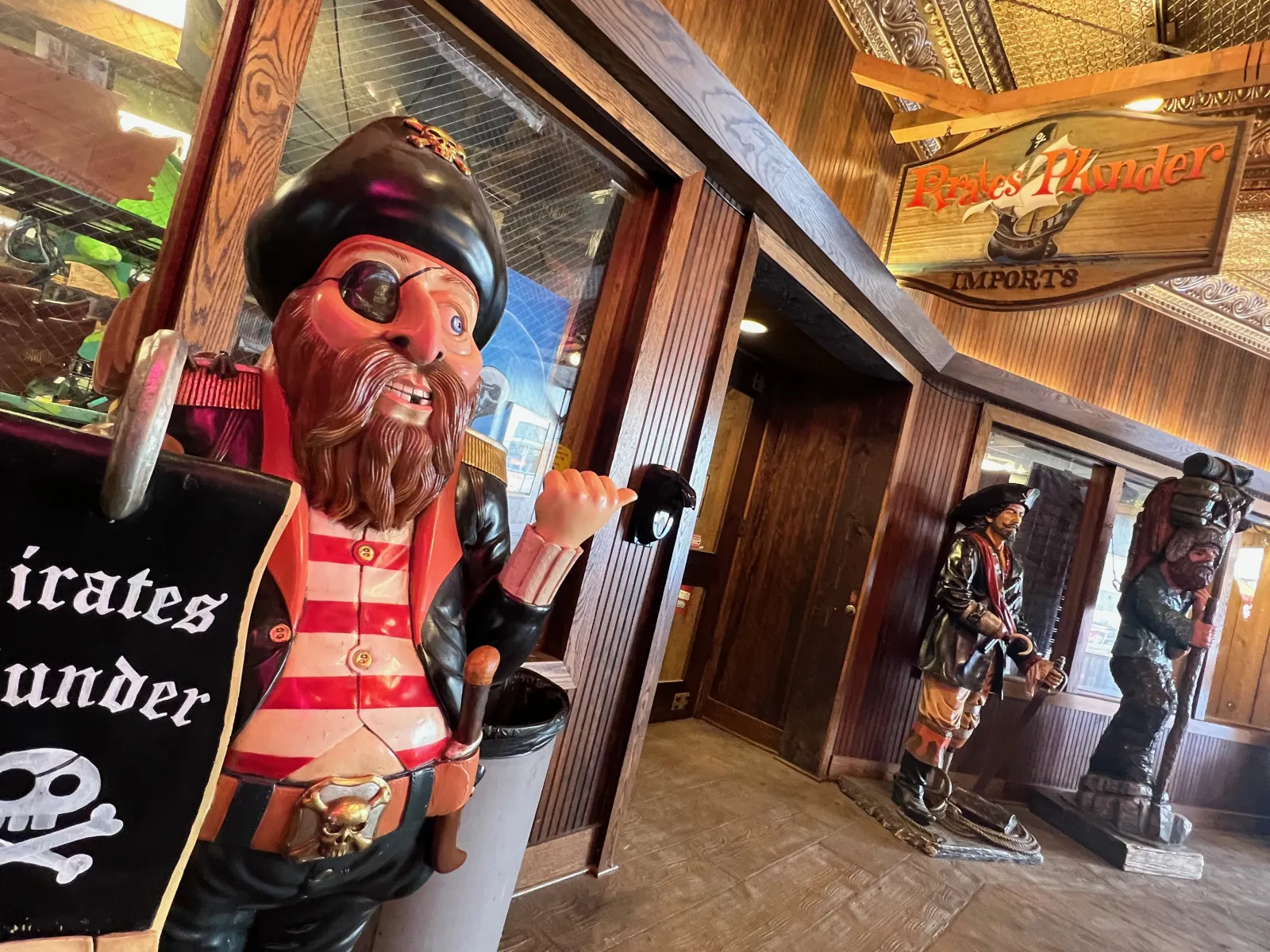 a pirate in a garment holding a sign