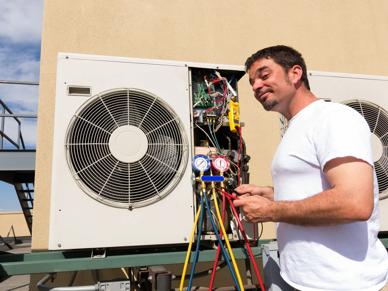 a man standing next to a fan
