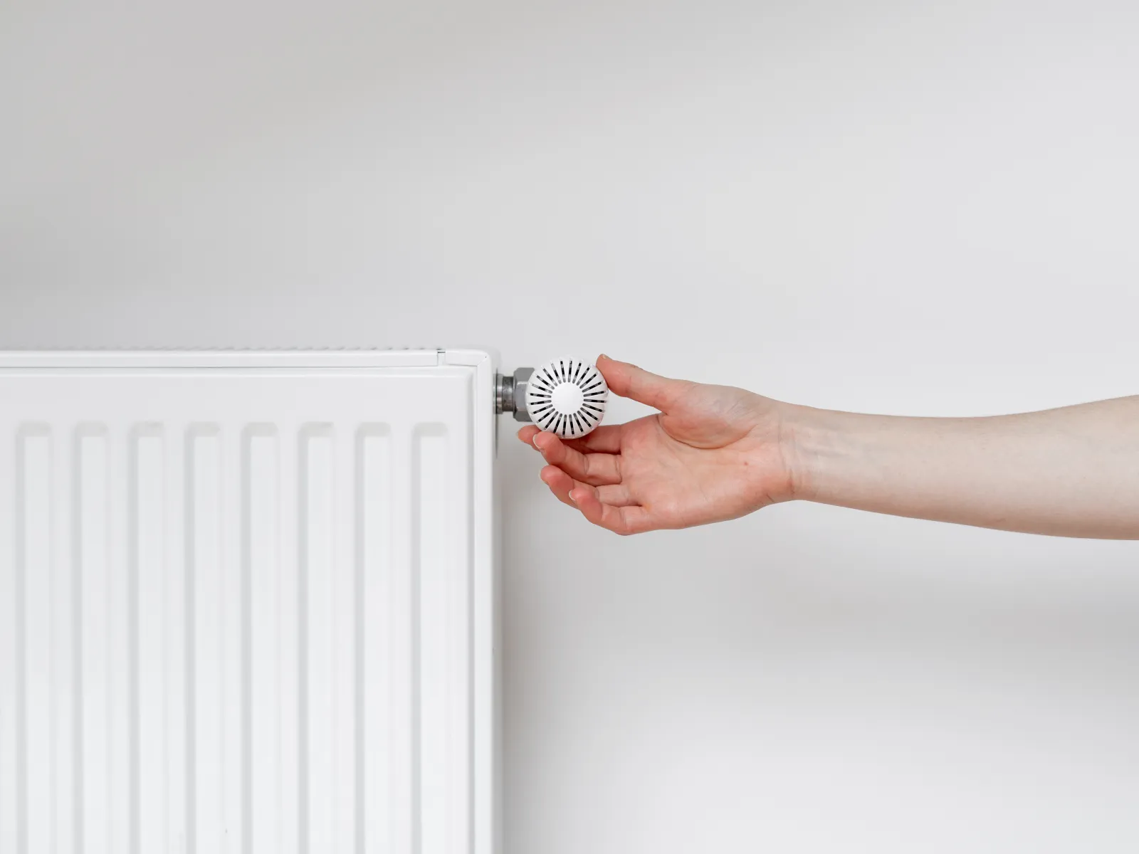 a hand holding a white object