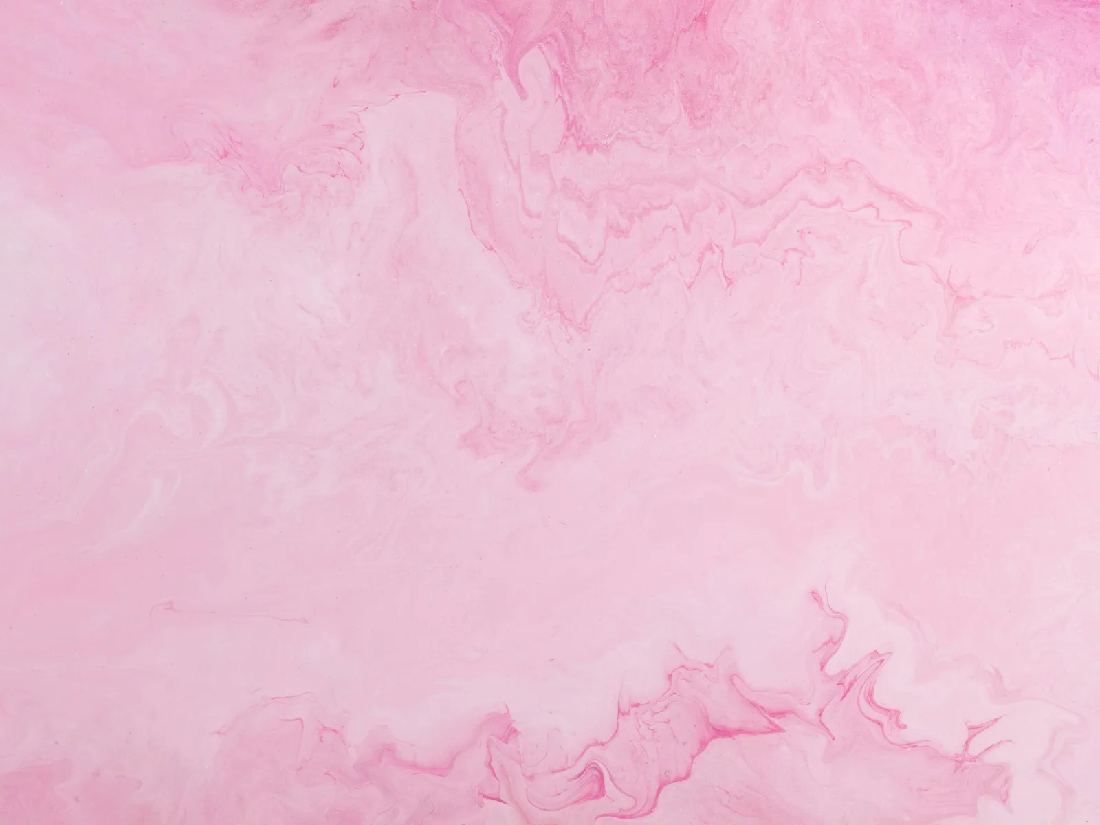 Soft pink marble texture with flowing, swirling patterns and gentle color gradients