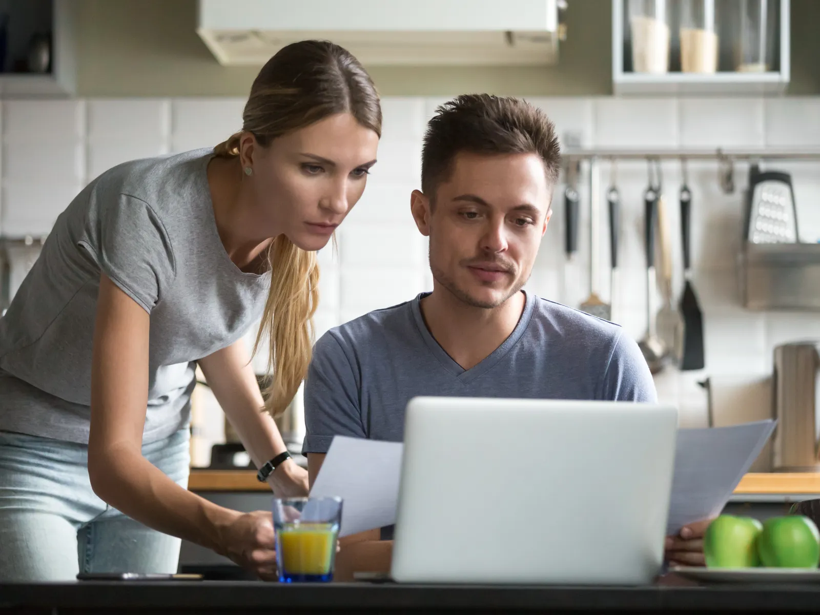 a group of people looking at a laptop
