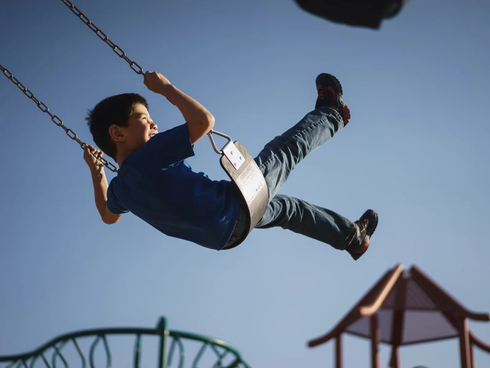 a man flying through the air on a swing
