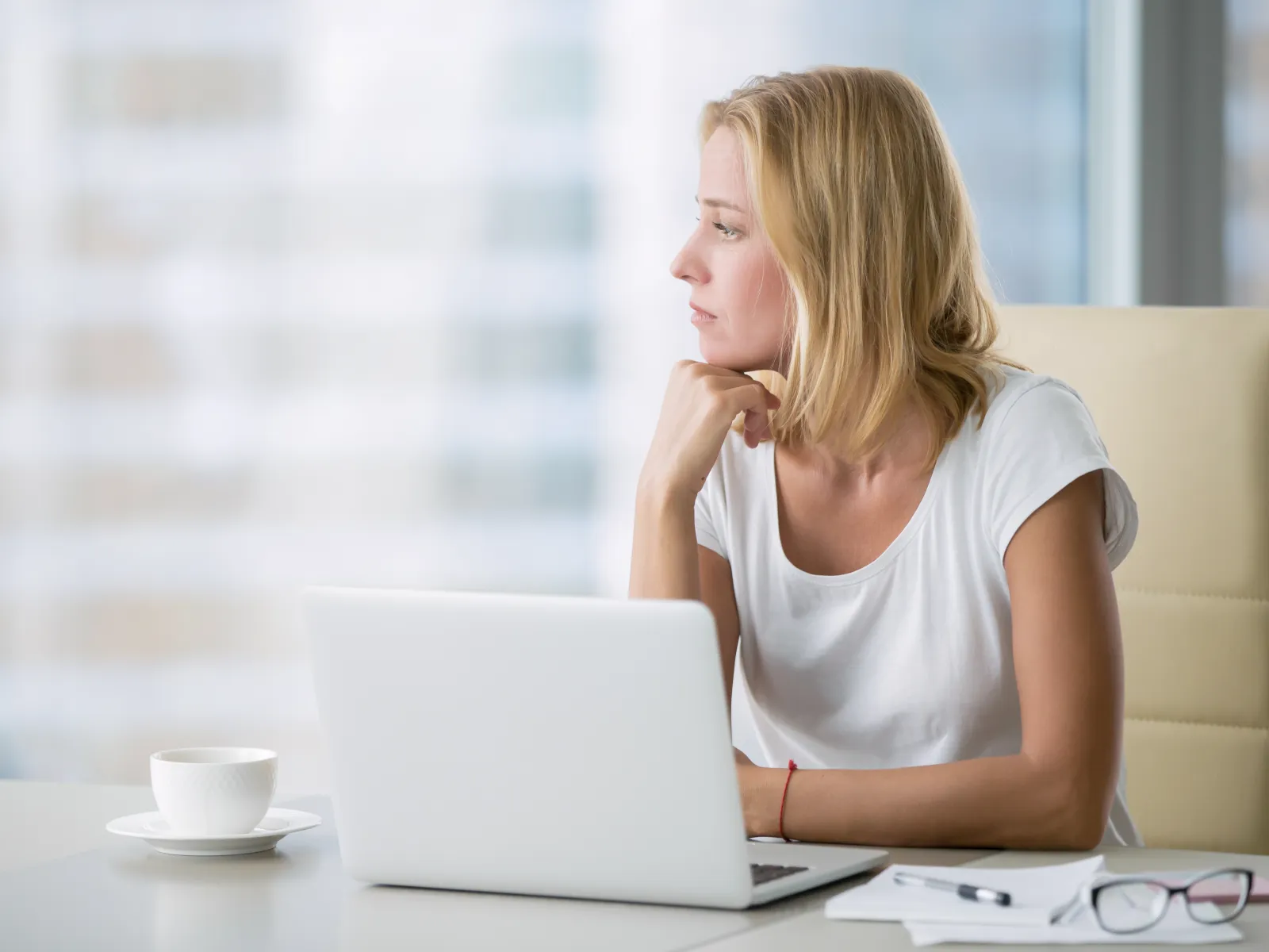 a woman sitting at a table using a laptop