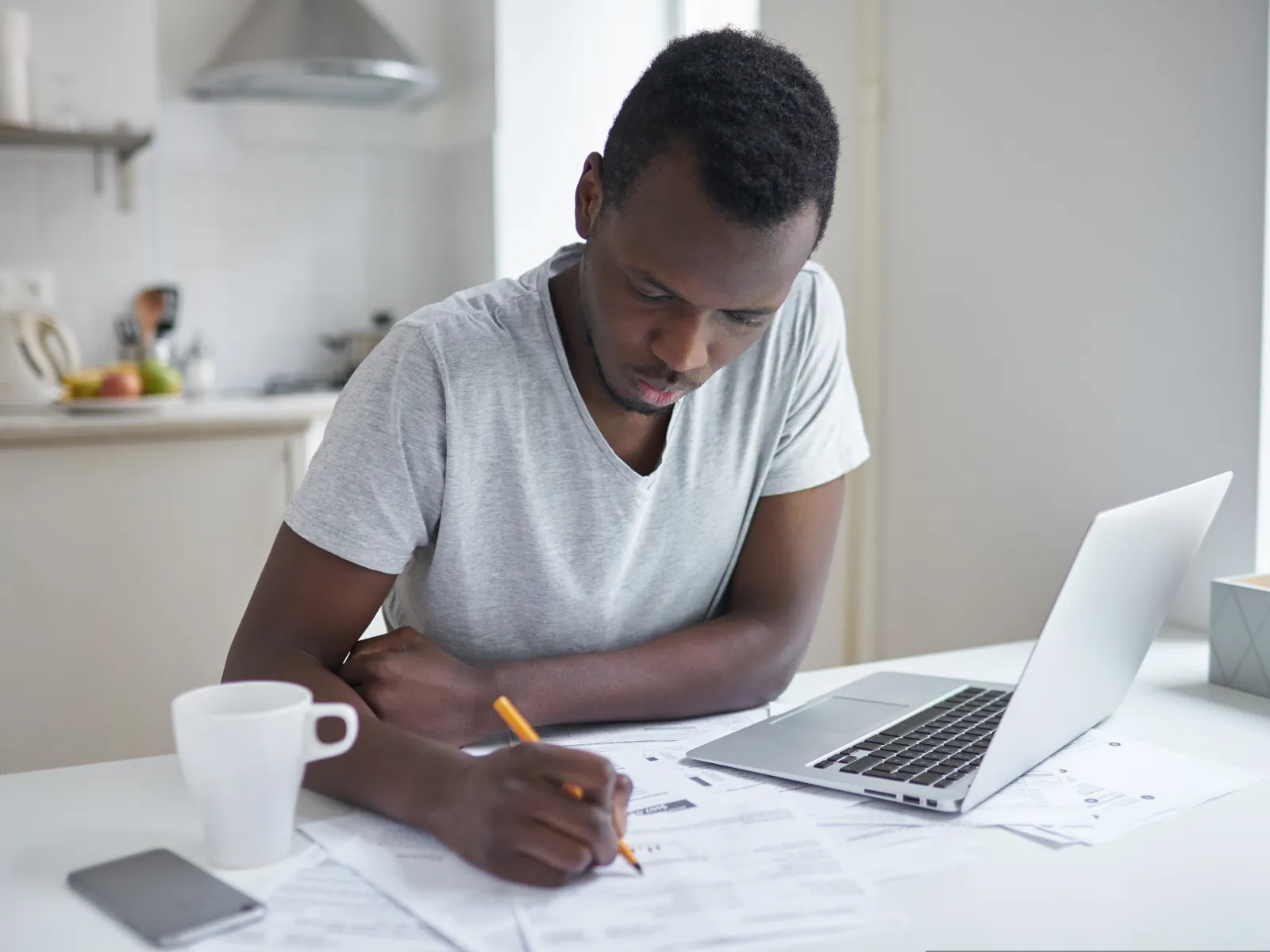 a man sitting at a table using a laptop