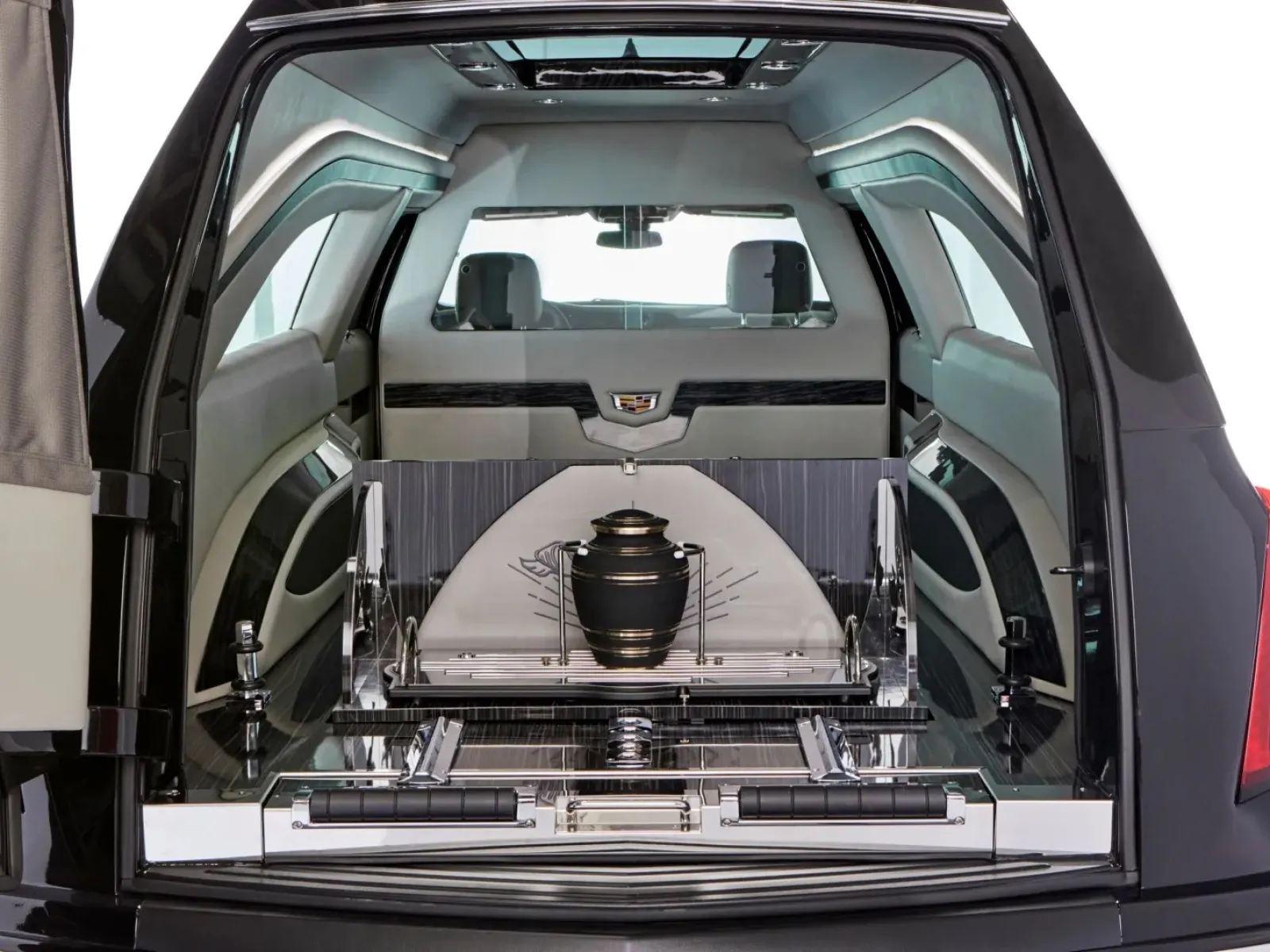 Interior of a luxury hearse showcasing a polished storage compartment for an urn.