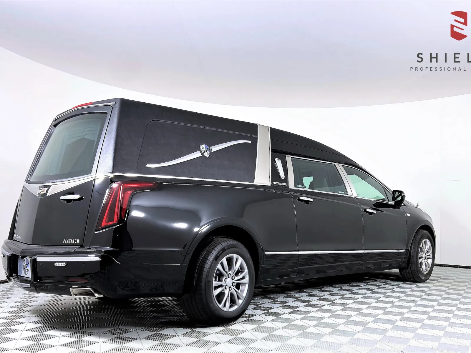 Luxury black hearse with sleek design, showcased in a professional studio setting.