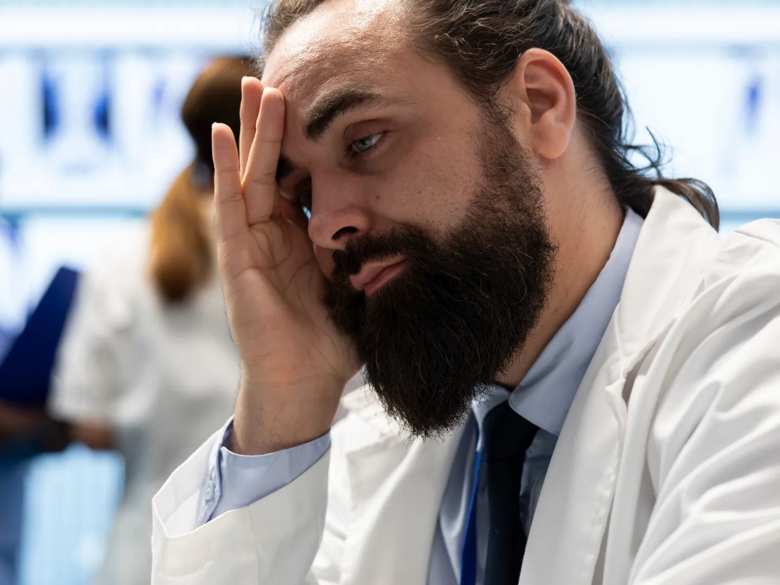 a man with his hand on his face