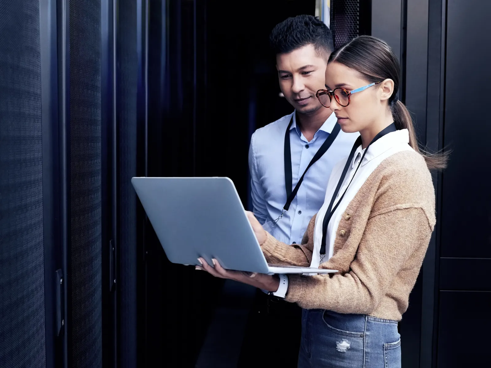 a man and a woman looking at a laptop