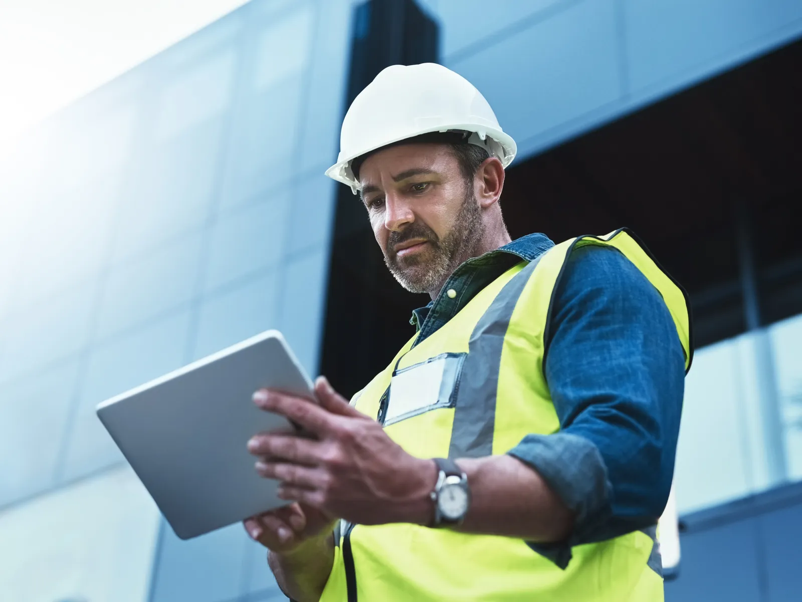 a man and a woman in hardhats in a factory