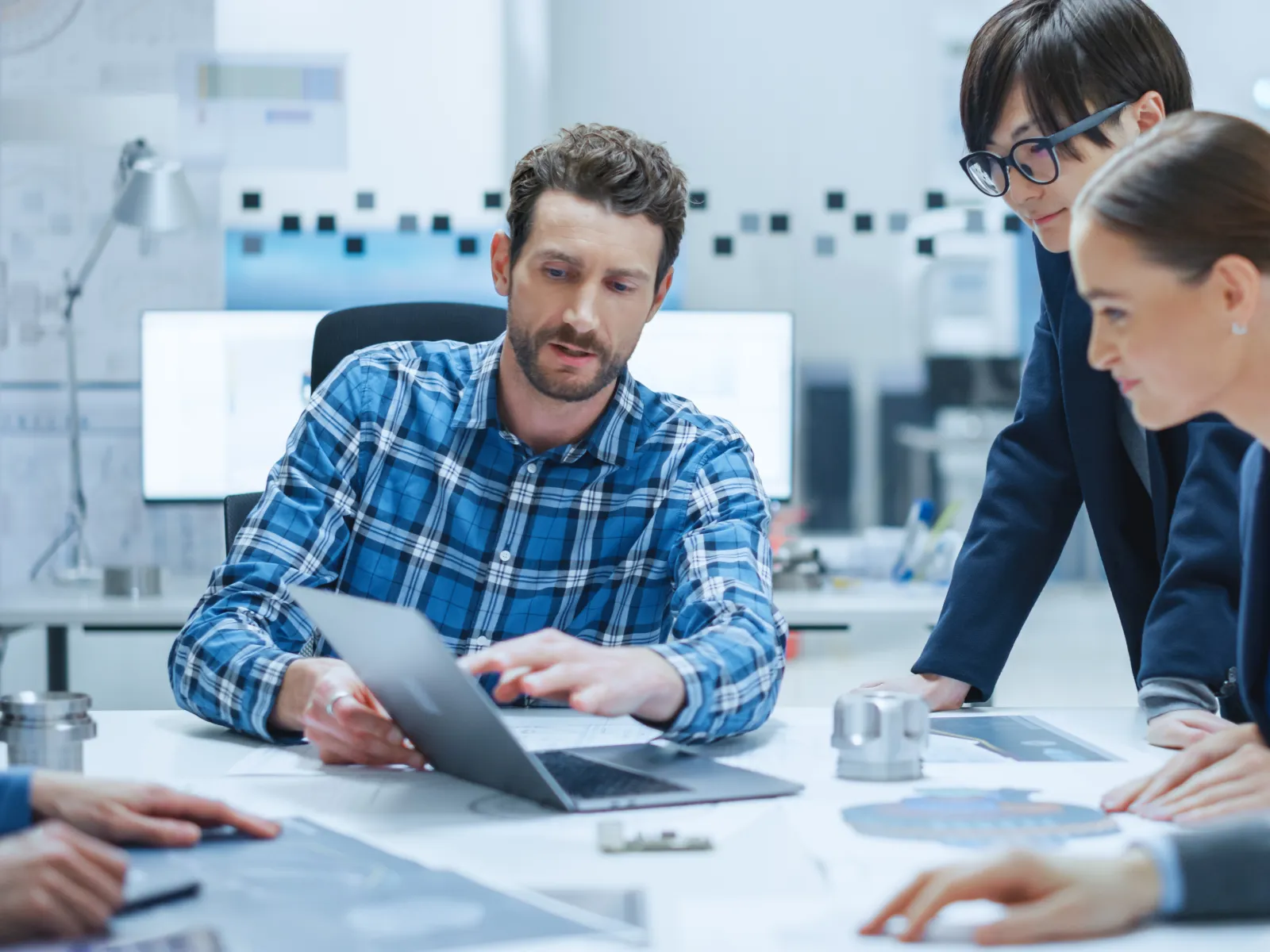 a man and a woman in hardhats in a factory